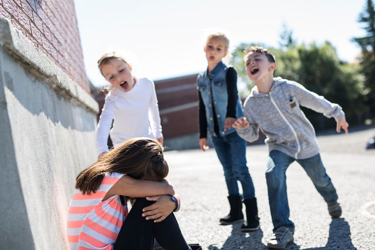 sad moment Elementary Age Bullying in Schoolyard