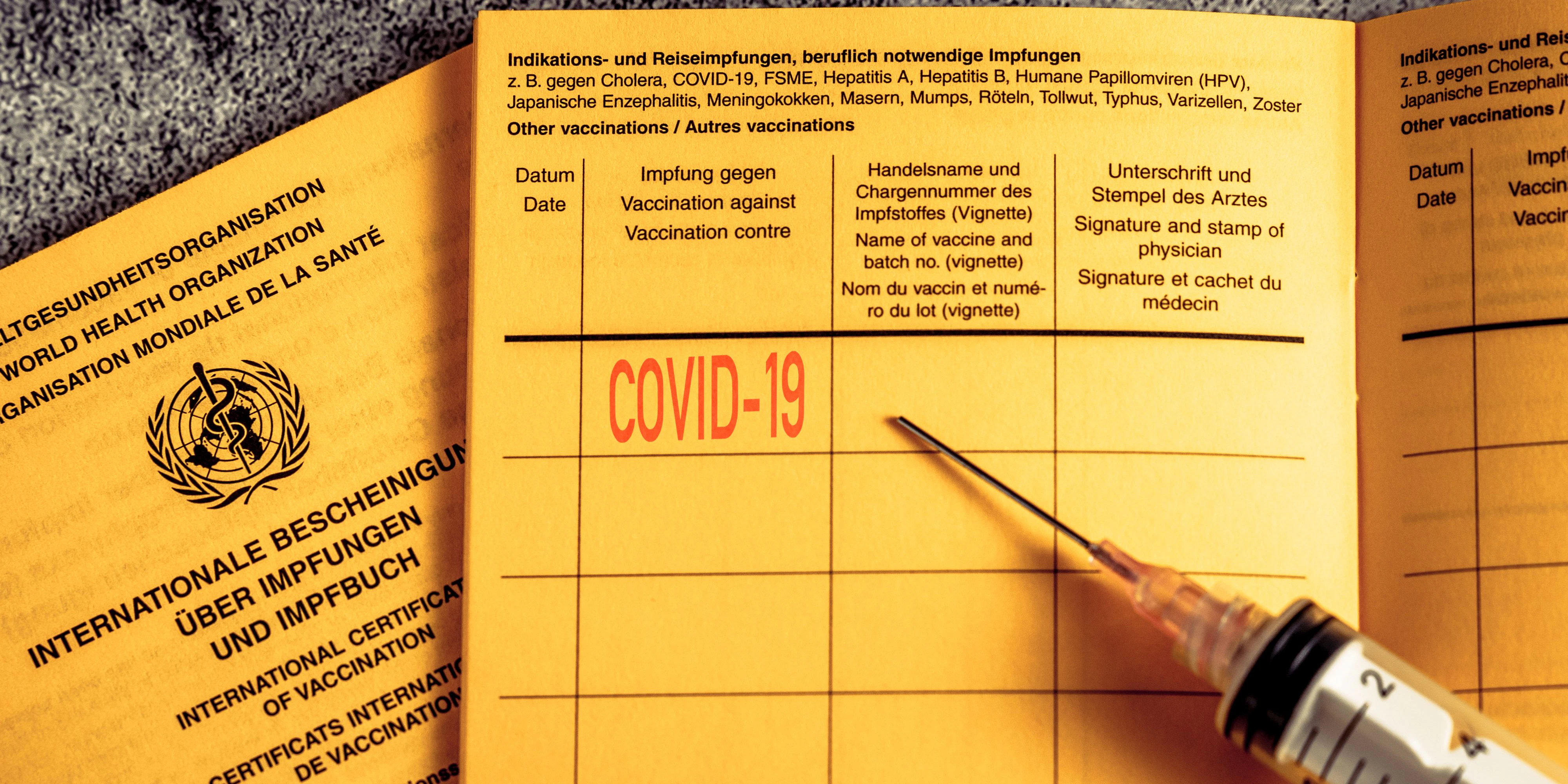 bavaria, germany - 08 april 2021: vaccination book with covid-19 vaccination card and a syringe. Internationaler Impfpass