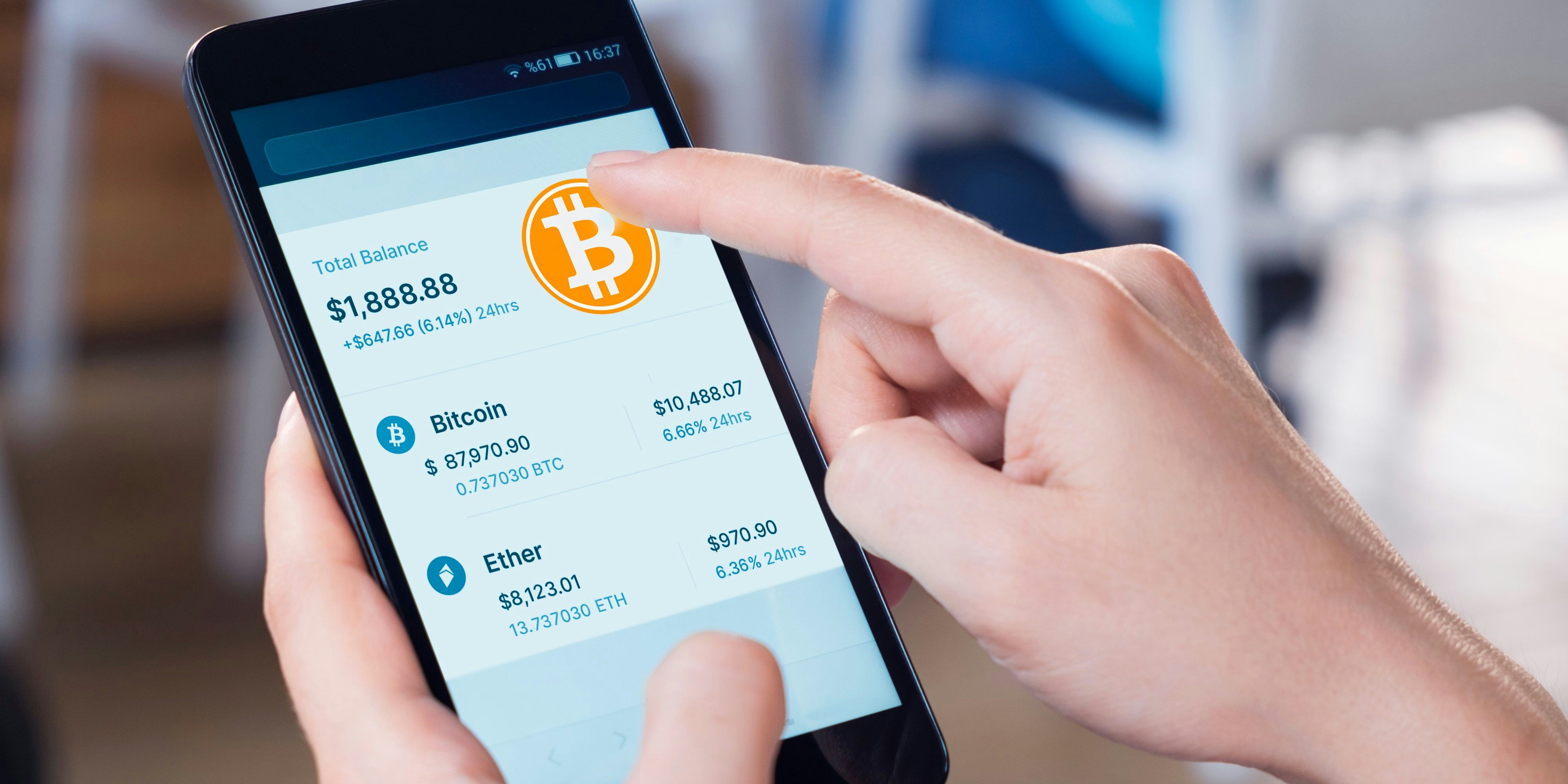 Woman using a smart phone displaying a bitcoin wallet screen.