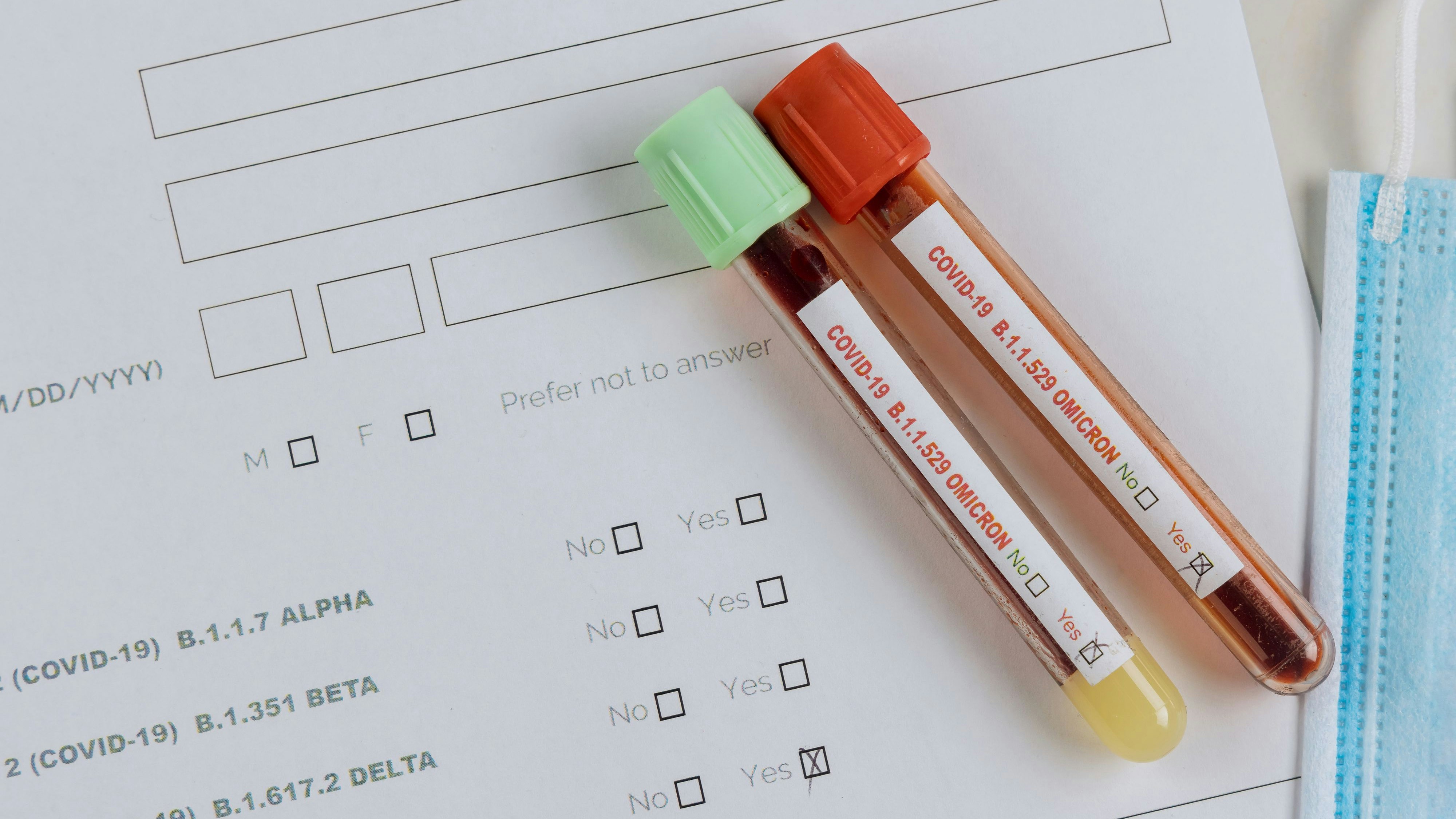 Medical professionals in the laboratory with tube containing blood samples for new version Omicron Covid-19 Coronavirus