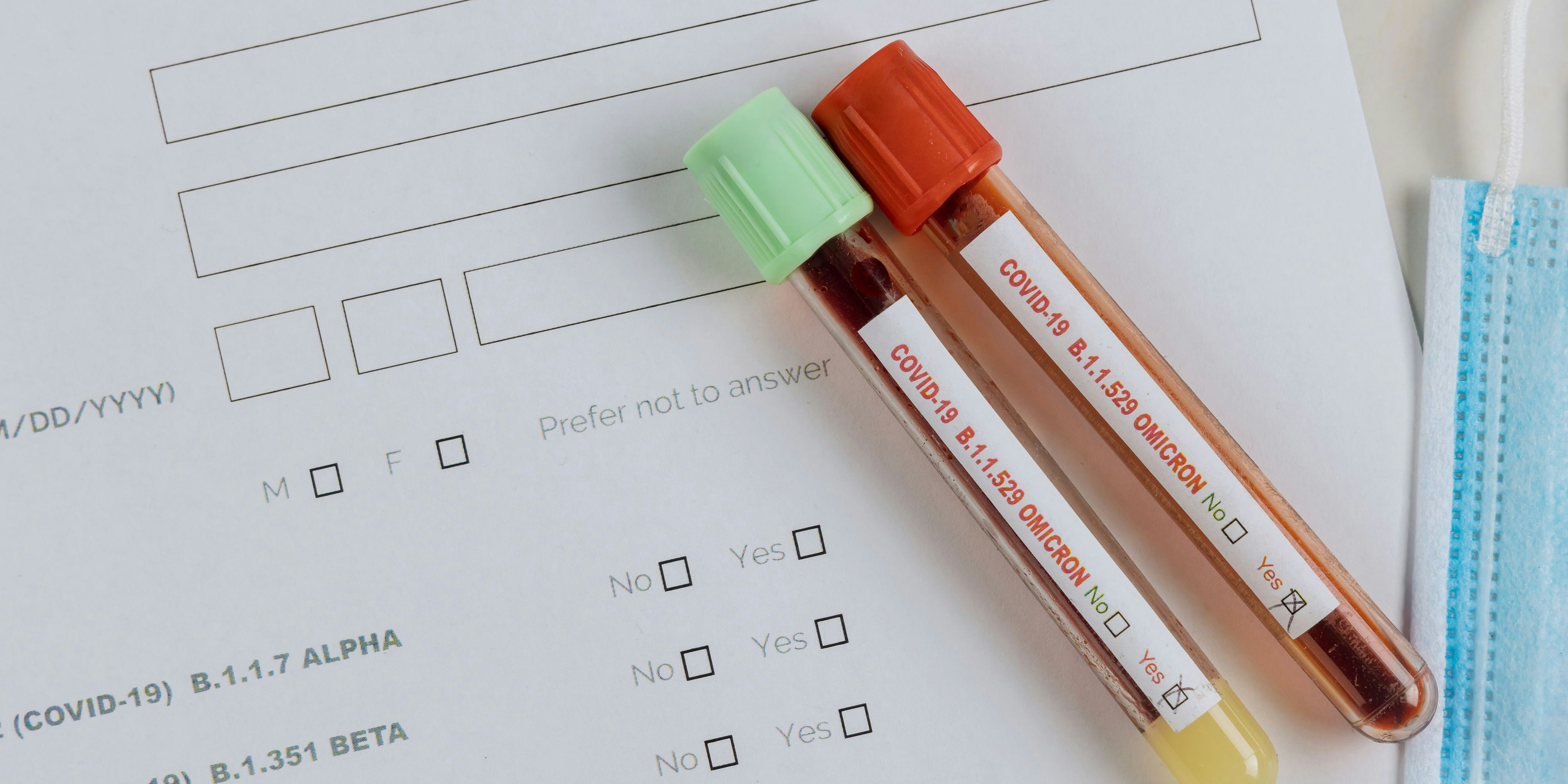 Medical professionals in the laboratory with tube containing blood samples for new version Omicron Covid-19 Coronavirus
