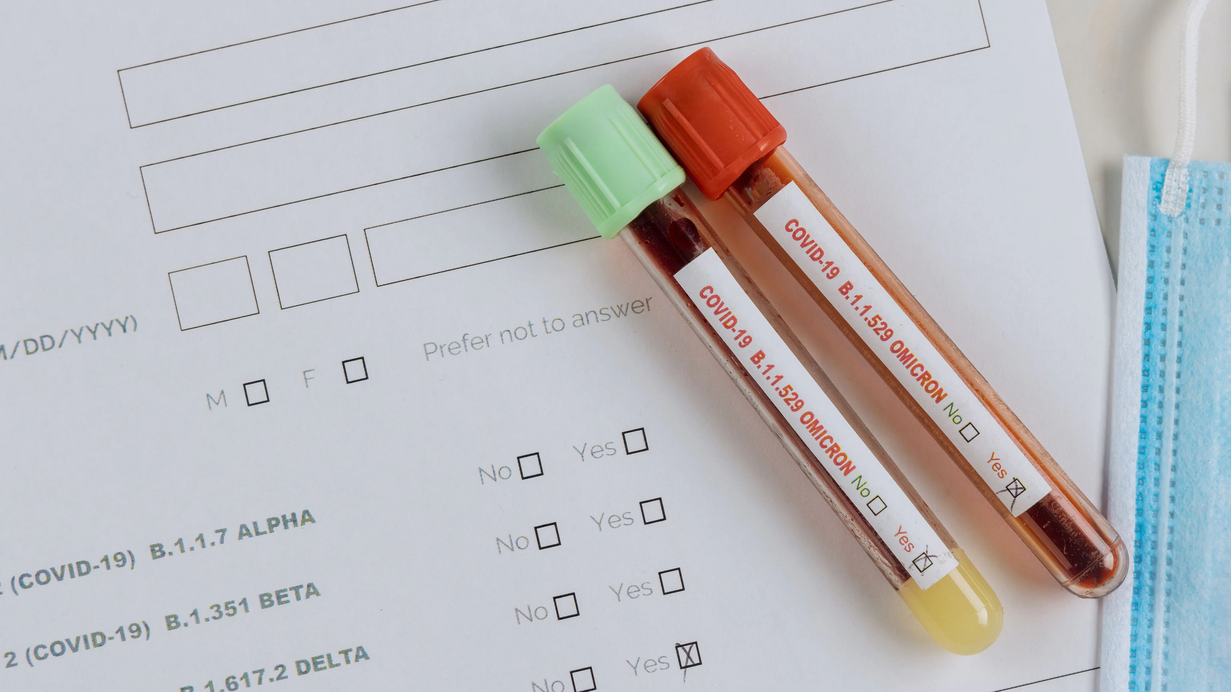 Medical professionals in the laboratory with tube containing blood samples for new version Omicron Covid-19 Coronavirus