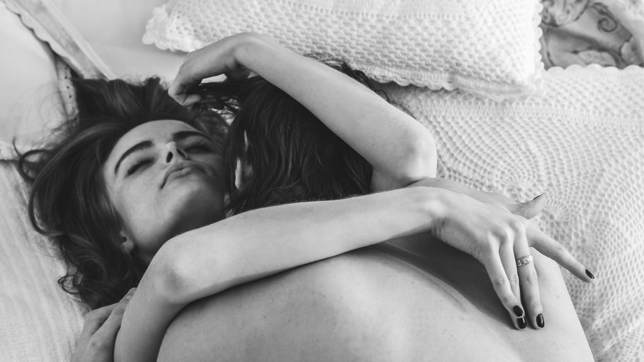 couple of young people having sex, they lie on the bed, hugging each other