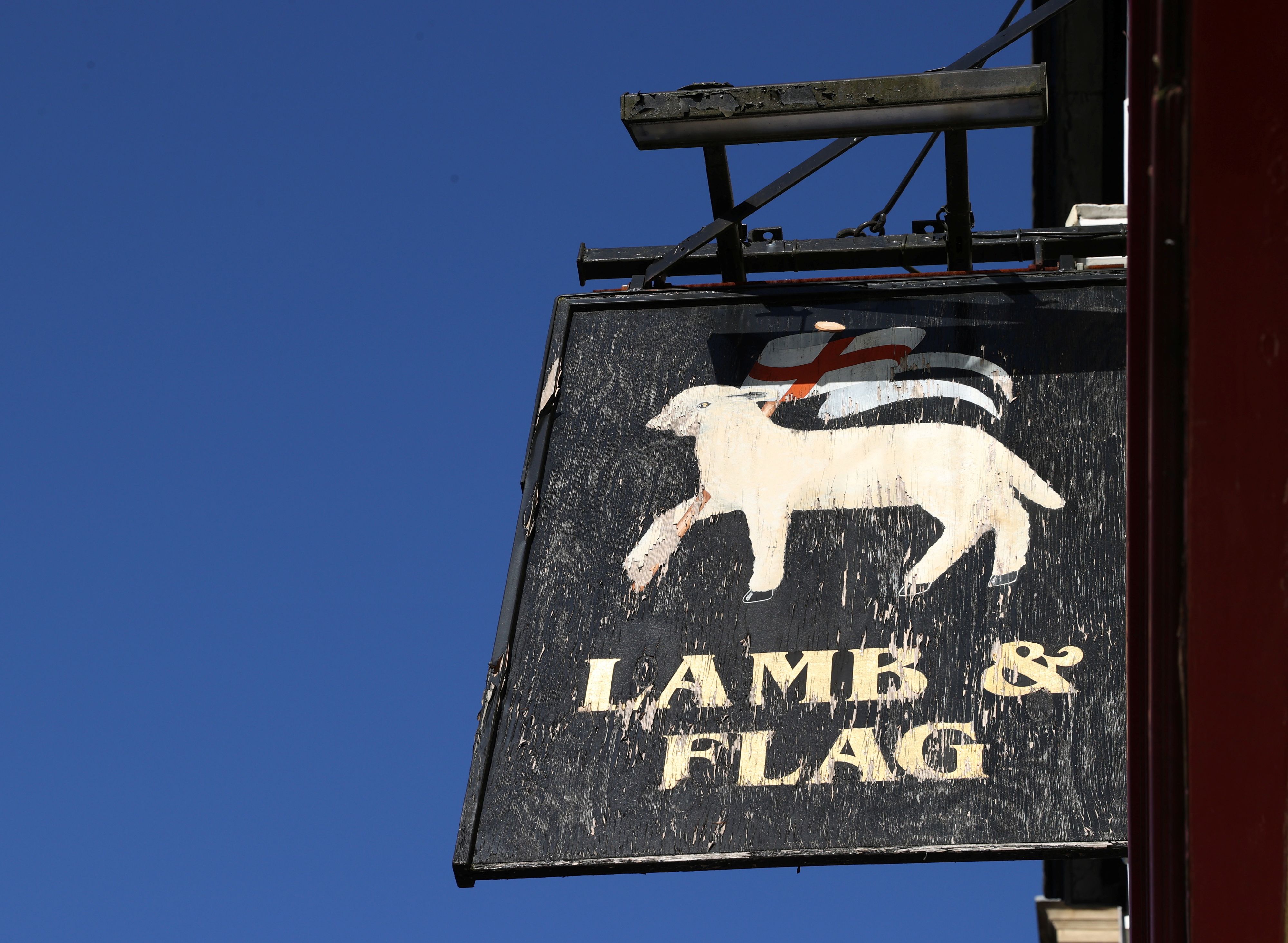 A sign for The Lamb and Flag is seen as the Grade-II listed pub is forced to close, after more than 400 years of business, following outbreak of the coronavirus disease (COVID-19) pandemic, in central Oxford, Britain, January 25, 2021.  REUTERS/Eddie Keogh