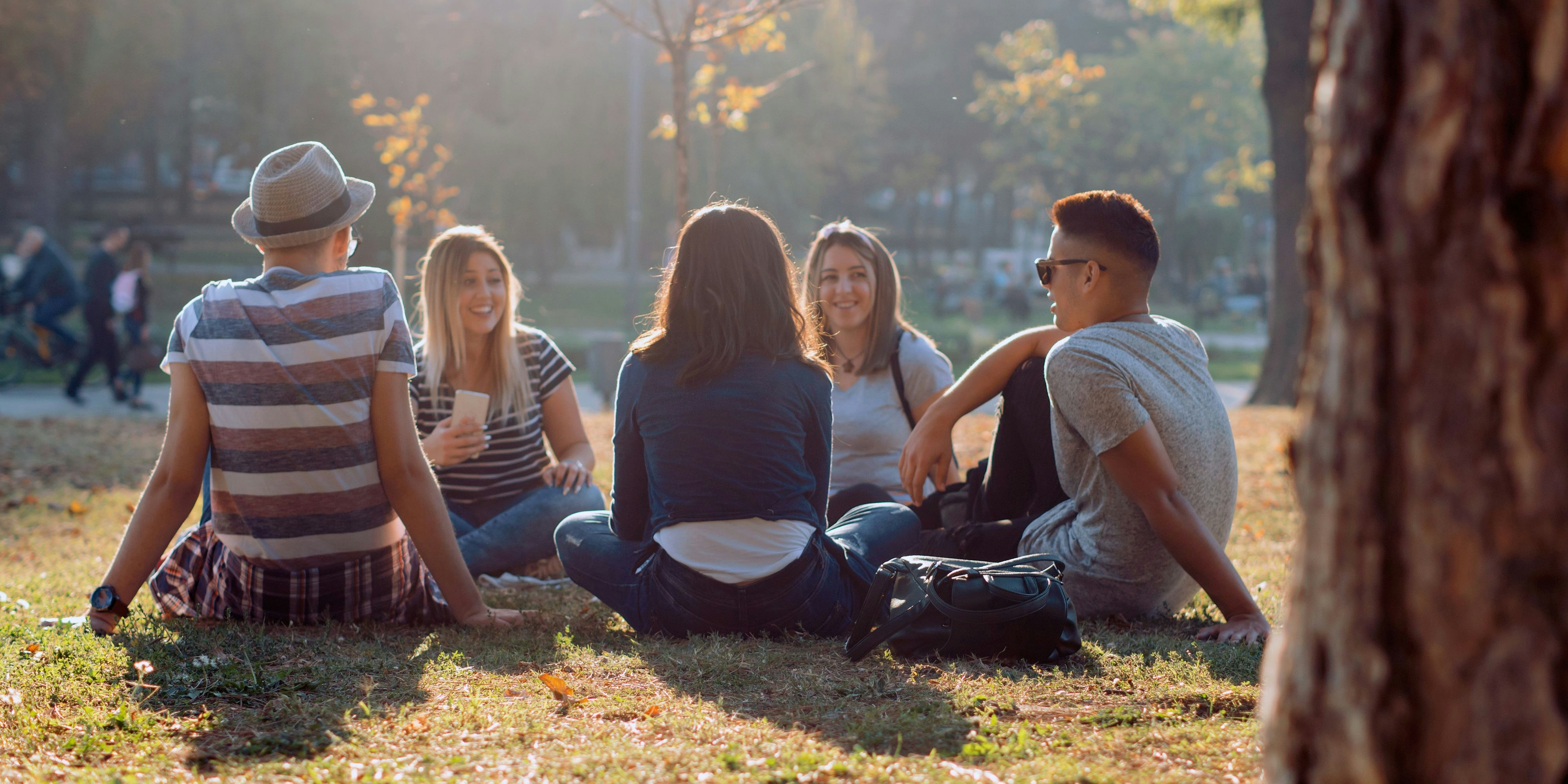 Group of five friends laughing out loud outdoor, sharing good and positive mood