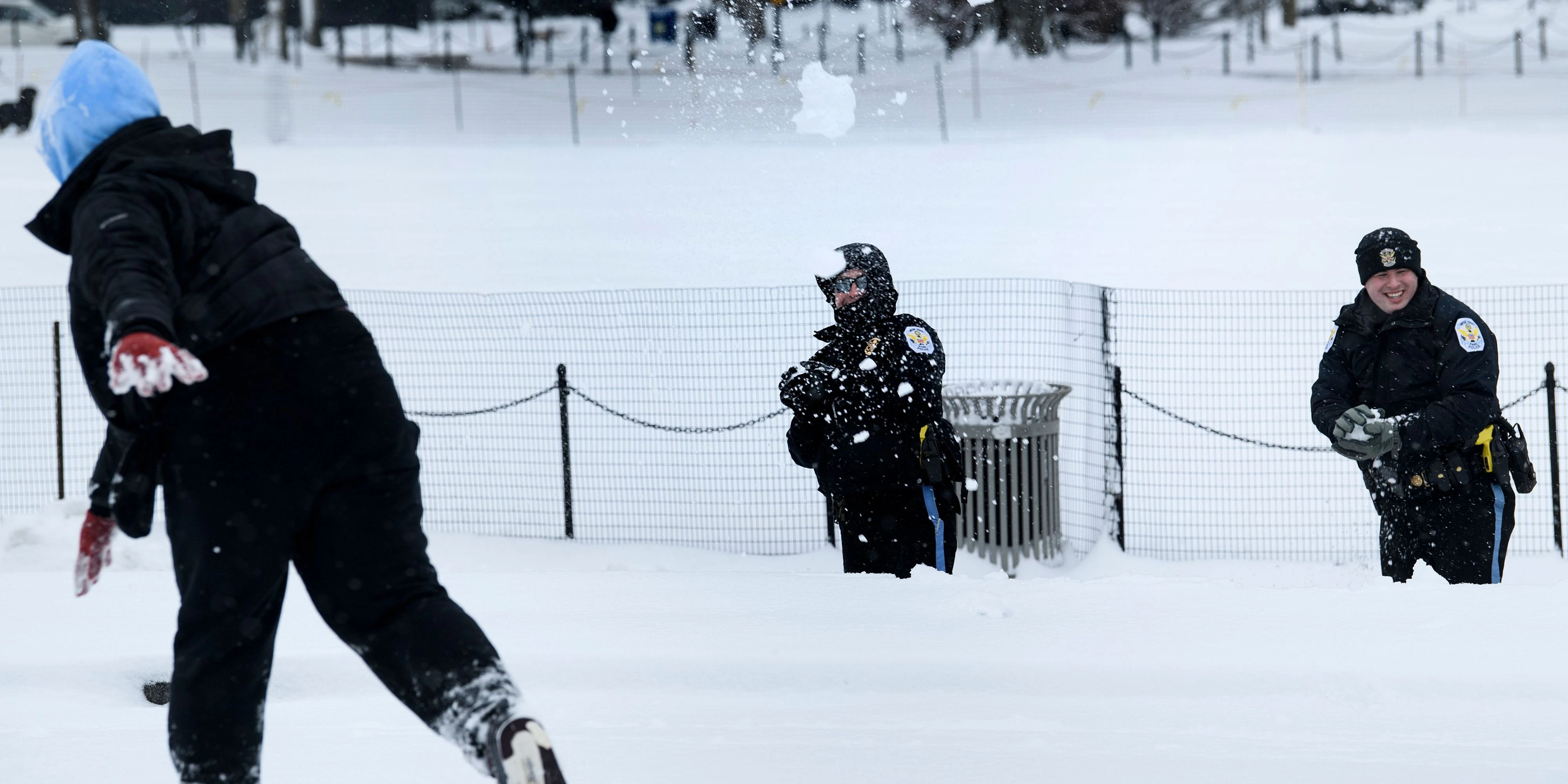 A person throws a snowball at US Park Police during a snowball fight on the National Mall during a winter storm January 13, 2019 in Washington, DC. 