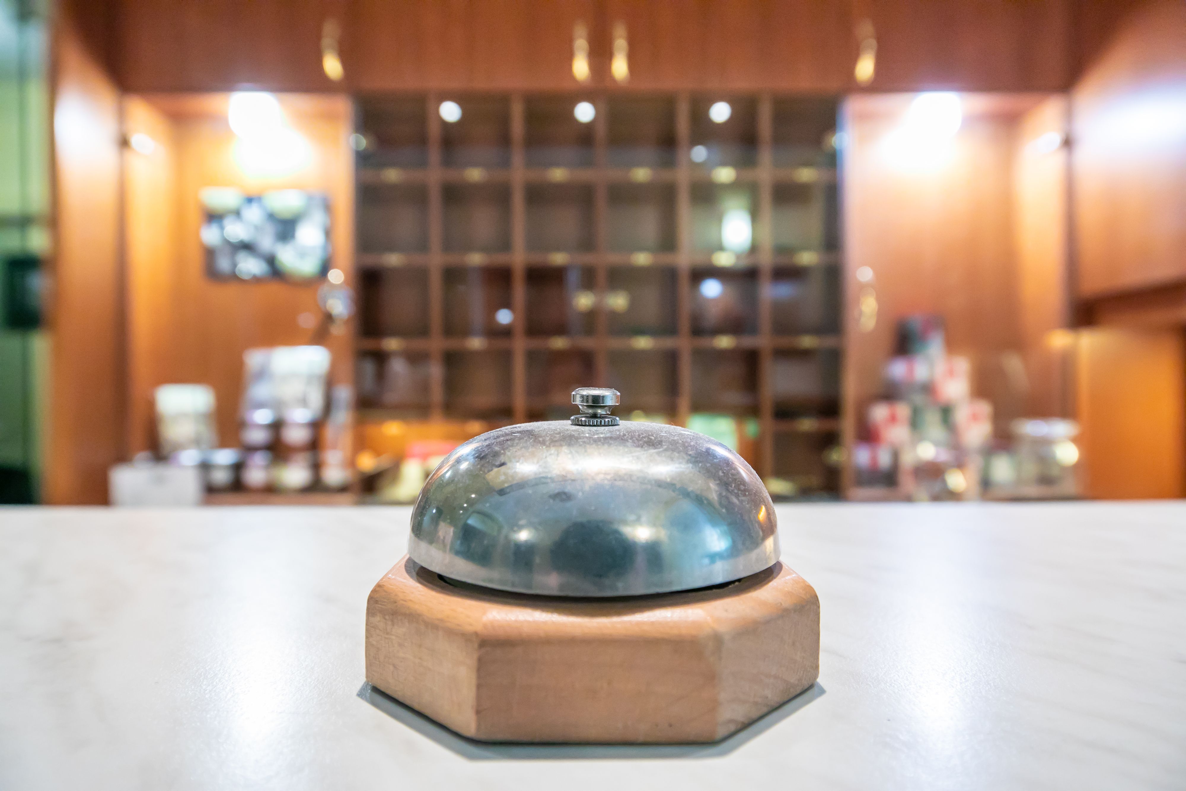 Vienna, Austria - May 17, 2020 - Due to the Corona pandemic most hotels suffer from a lack of guests as boarders are closed and tourists are missing. The hotel bell at a reception stays untouched and dust slowly forms a layer.