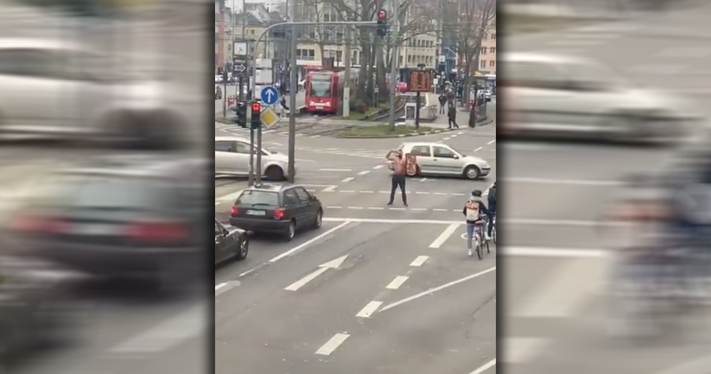 Der Musiker steht mitten auf einer Kreuzung und lässt sich feiern.