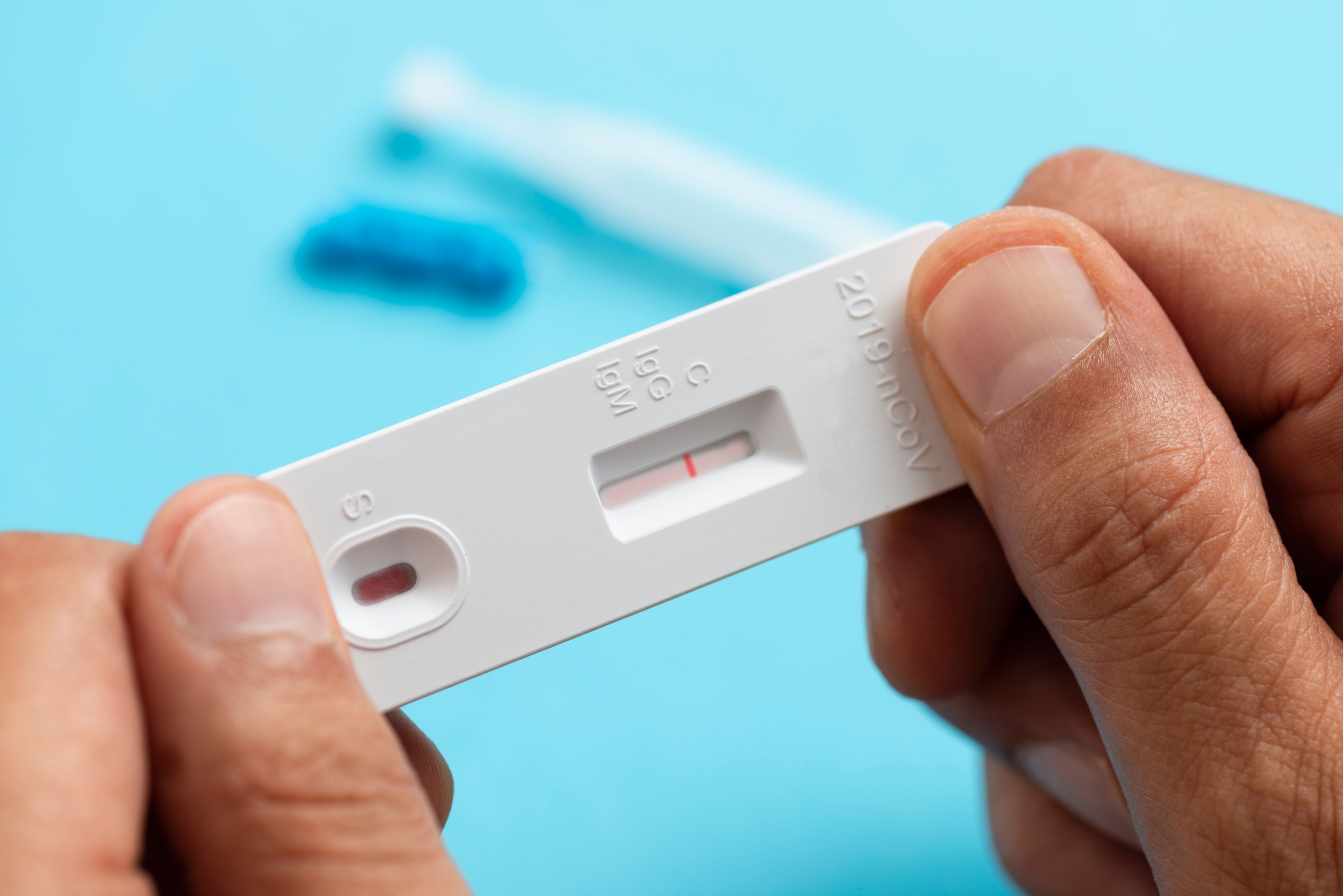 Man looking at COVID-19 rapid test result. Self - sampling. IgG.