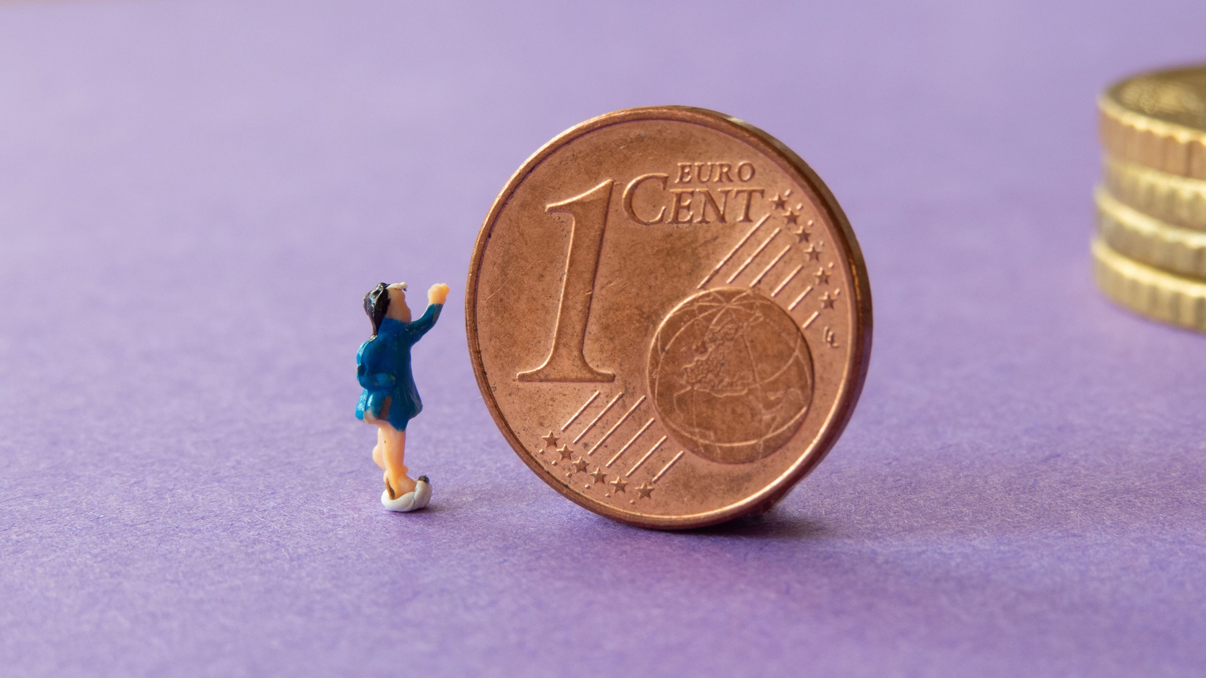 Eine Miniatur vor einer Ein-Cent-Münze. Symbolbild