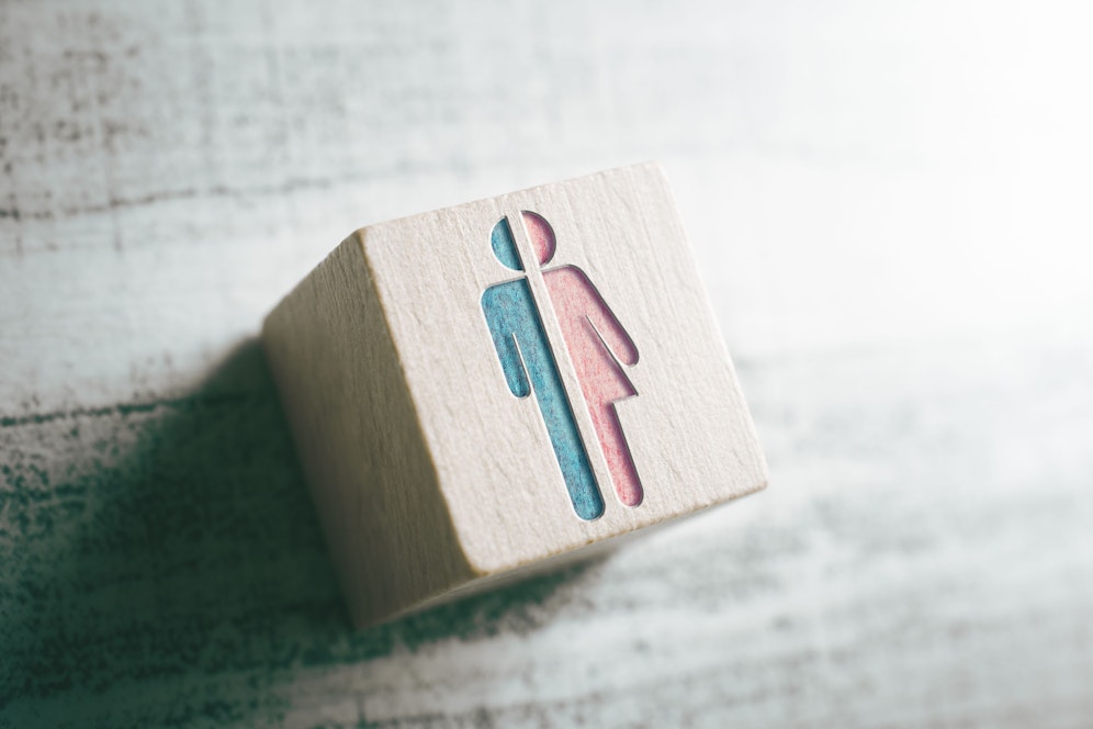 Gender Icons For Male And Female Cut In Half On Wooden Block On A Table