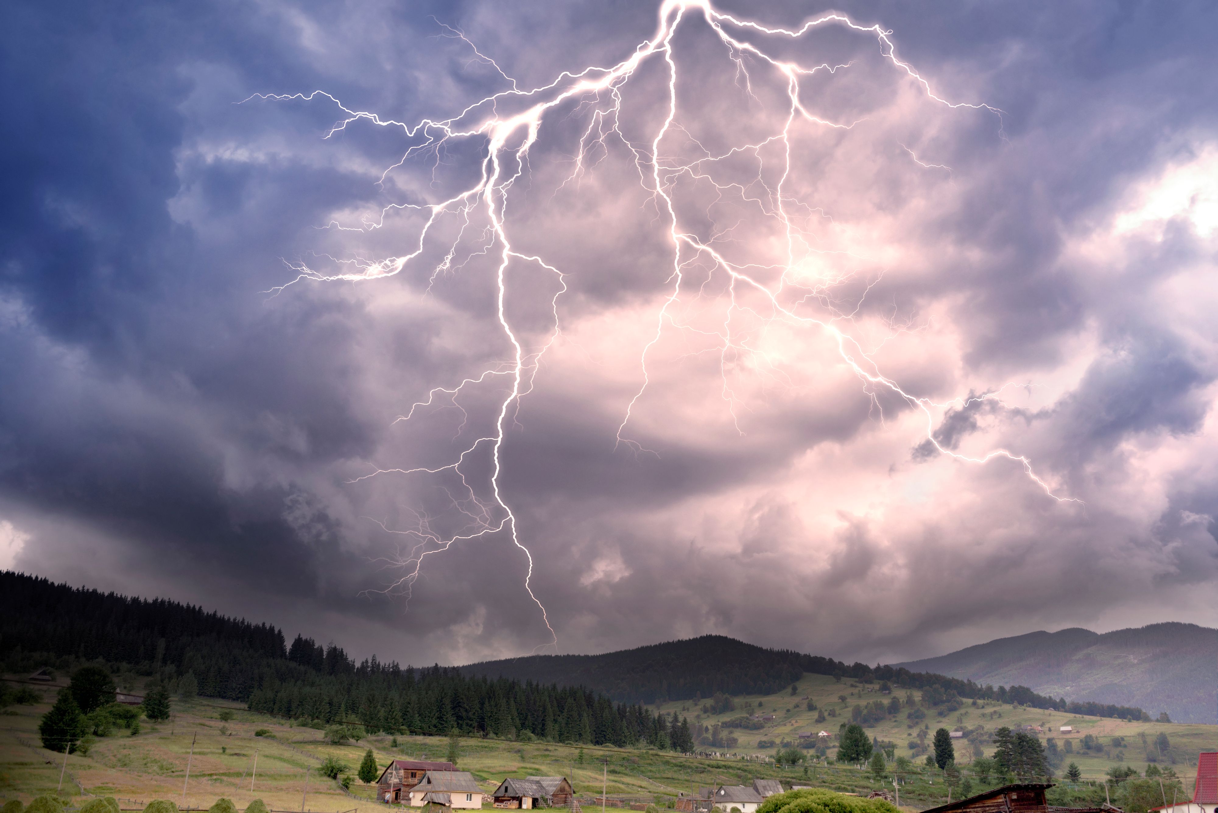 Storm clouds in the Alps after a strong thunderstorm with lightning and thunder over the tops of the ridges, with wind and rain