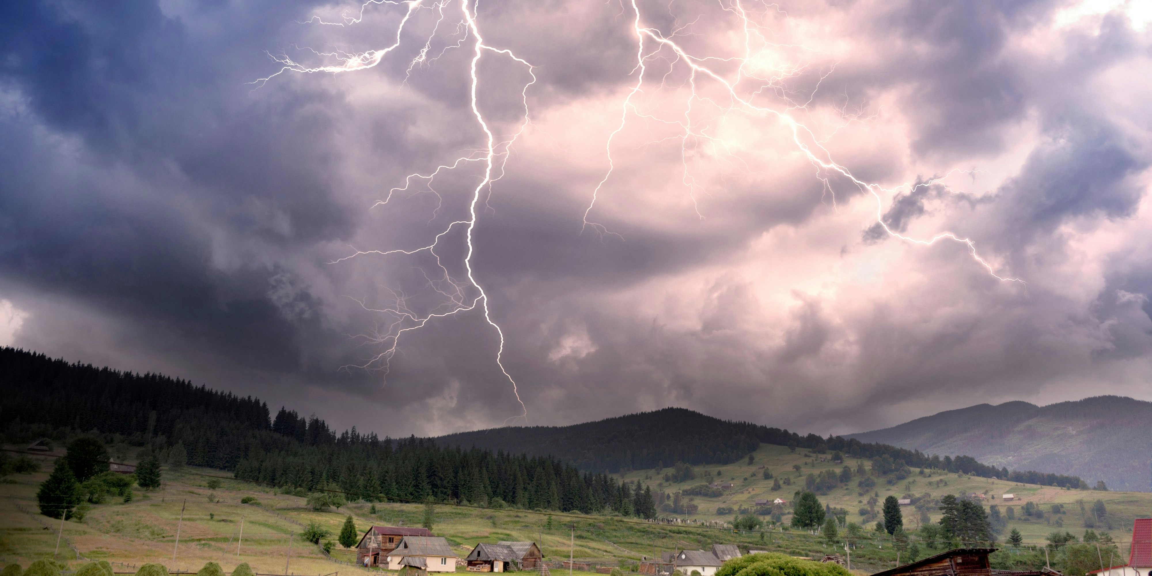 Storm clouds in the Alps after a strong thunderstorm with lightning and thunder over the tops of the ridges, with wind and rain