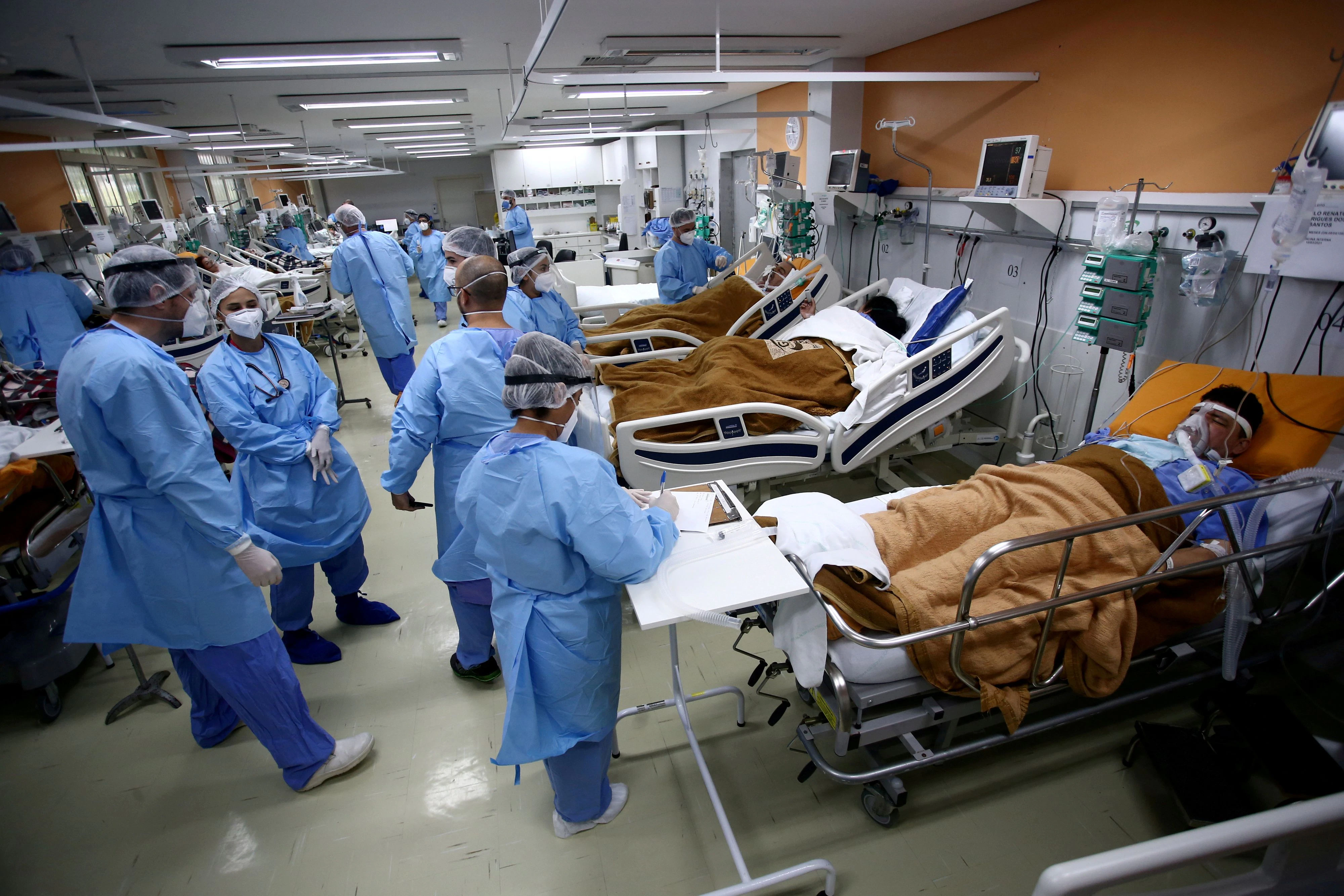 FILE PHOTO: Medical workers take care of patients in the emergency room of the Nossa Senhora da Conceicao hospital that is overcrowding because of the coronavirus outbreak, in Porto Alegre, Brazil, March 11, 2021.  REUTERS/Diego Vara/File Photo