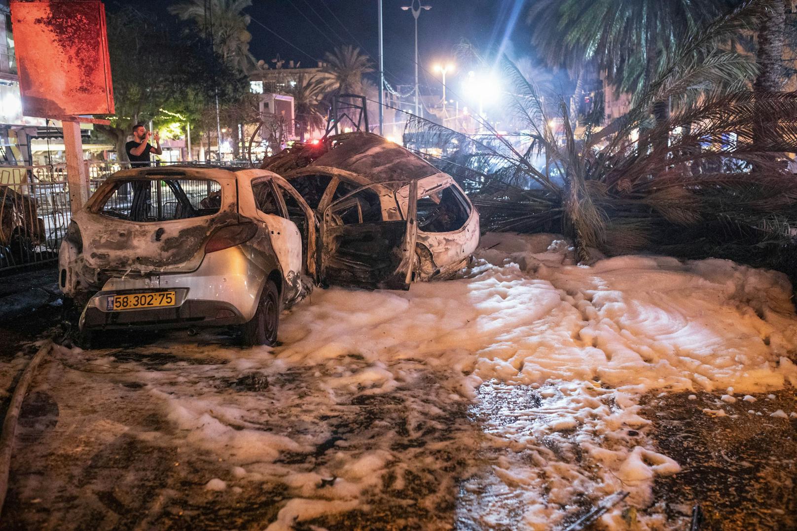 In Holon, nahe Tel Aviv, wurden mehrere Autos und auch ein Bus getroffen und brannten aus.