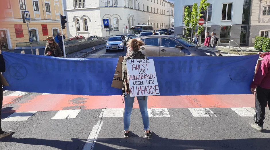 Die drei Demonstranten blockierten die Straße am Pfarrplatz.