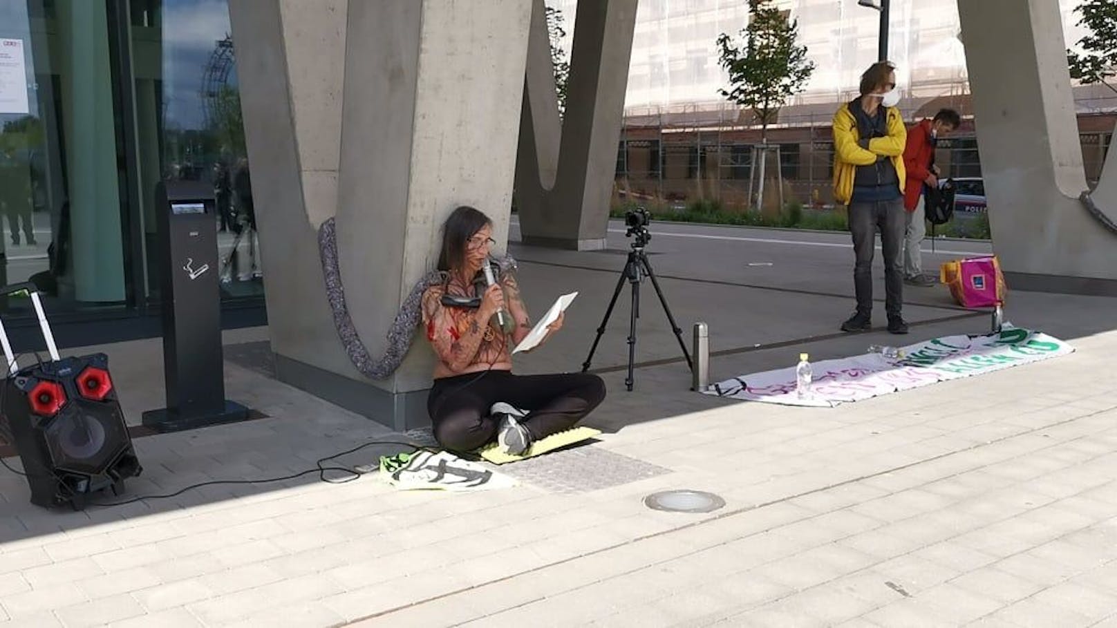 Eine Aktivistin kettete sich am Donnerstag am Praterstern an einen Betonpfeiler.