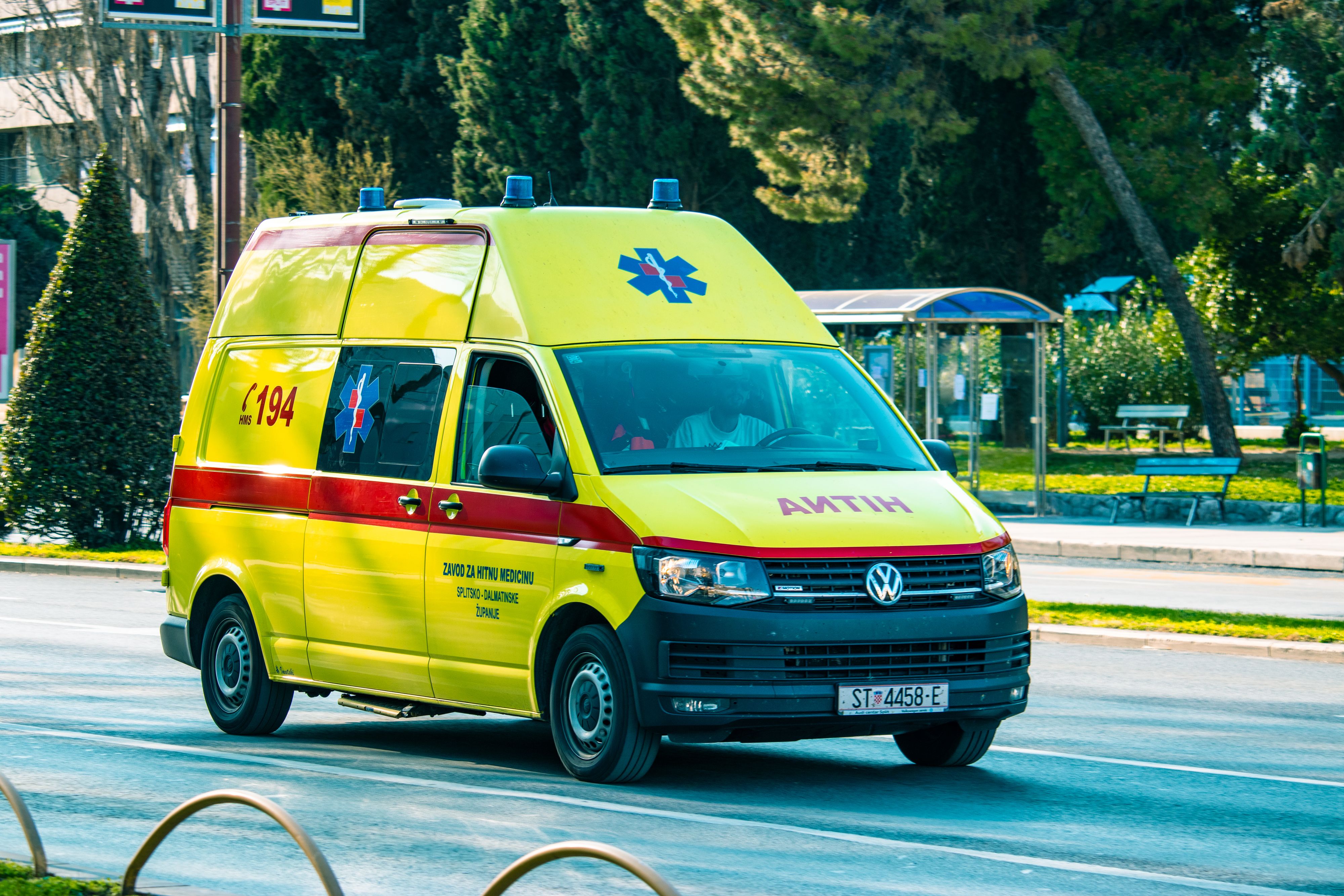 Yellow volkswagen ambulance driving on the street of Split, Croatia during the corona virus outbreak.