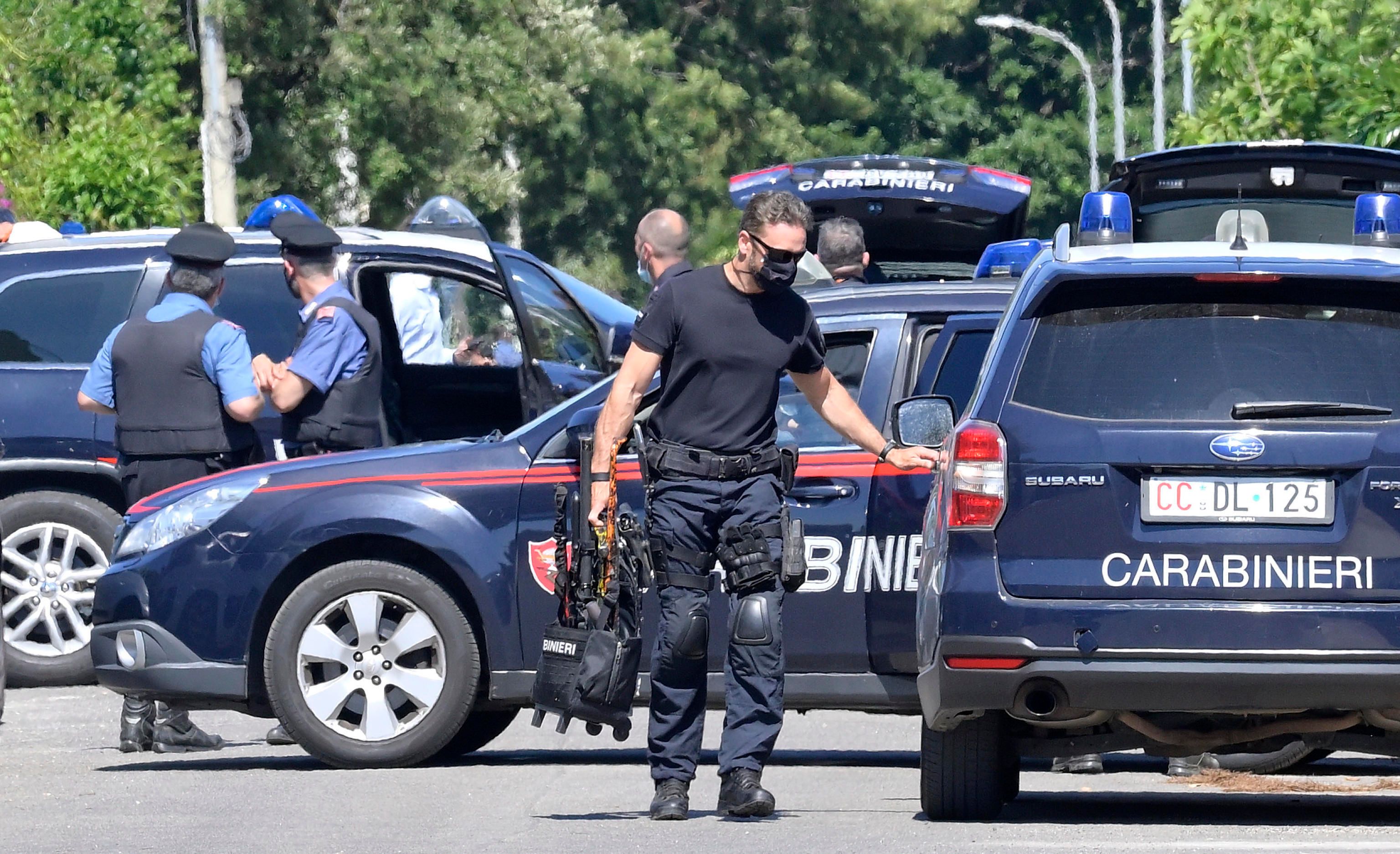 epa09267578 Carabinieri special unit officers take position in Ardea, near Rome, Italy, 13 June 2021. The man who allegedly shot and killed two brothers and an elderly person who was passing by bicycle this morning in Ardea, has barricaded himself for more than three hours. A negotiator is at work, but the suspect doesn't seem to be responding. On site are members of the API (first intervention team) task force of the Provincial Command of Rome.  EPA-EFE/CLAUDIO PERI