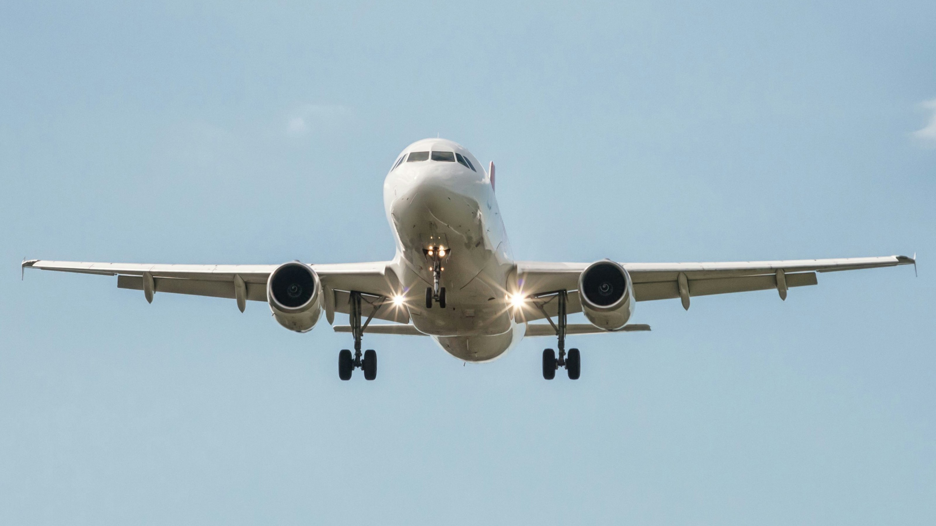passenger aircraft prepares landing with landing gear extended