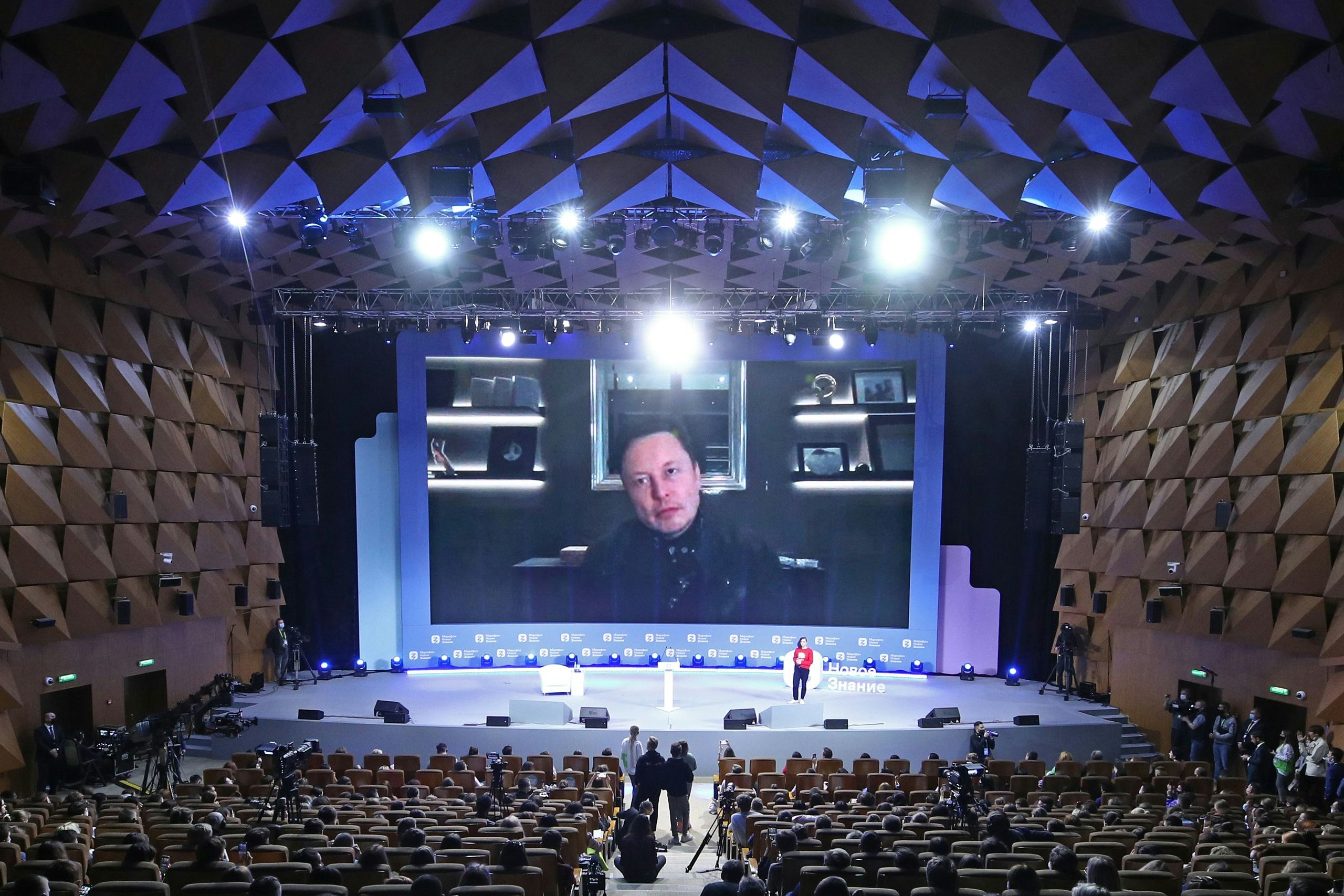 Download von www.picturedesk.com am 29.06.2021 (12:49).  MOSCOW, RUSSIA - MAY 21, 2021: The screen behind shows SpaceX CEO and Tesla product architect Elon Musk as he joins the New Knowledge forum via videolink at the Moscow Digital Business Space (formerly known as Moscow Central House of Entrepreneurs). Sergei Bobylev/TASS - 20210521_PD1278 - Rechteinfo: Rights Managed (RM)