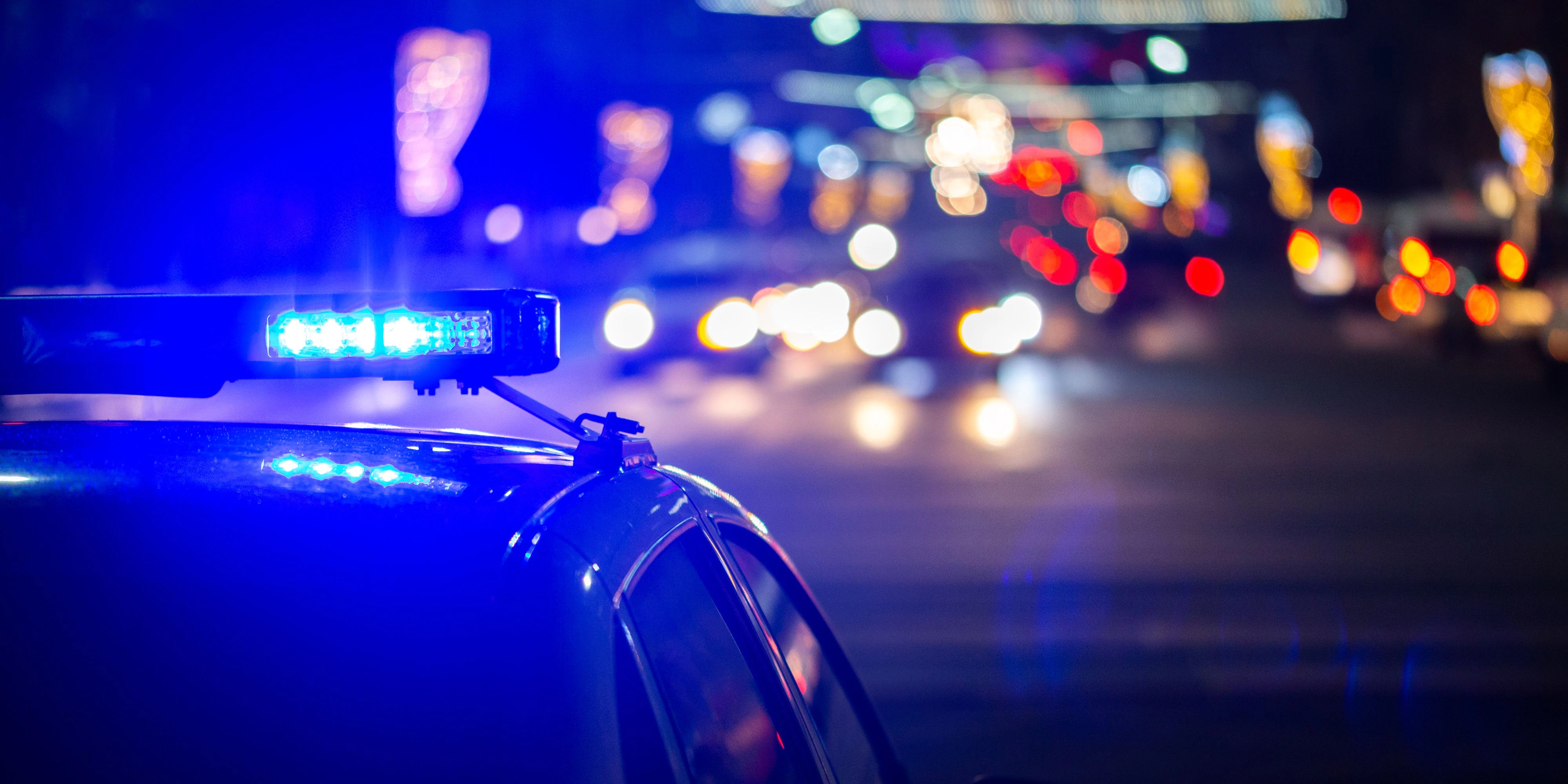 police car lights at night in city with selective focus and bokeh.
