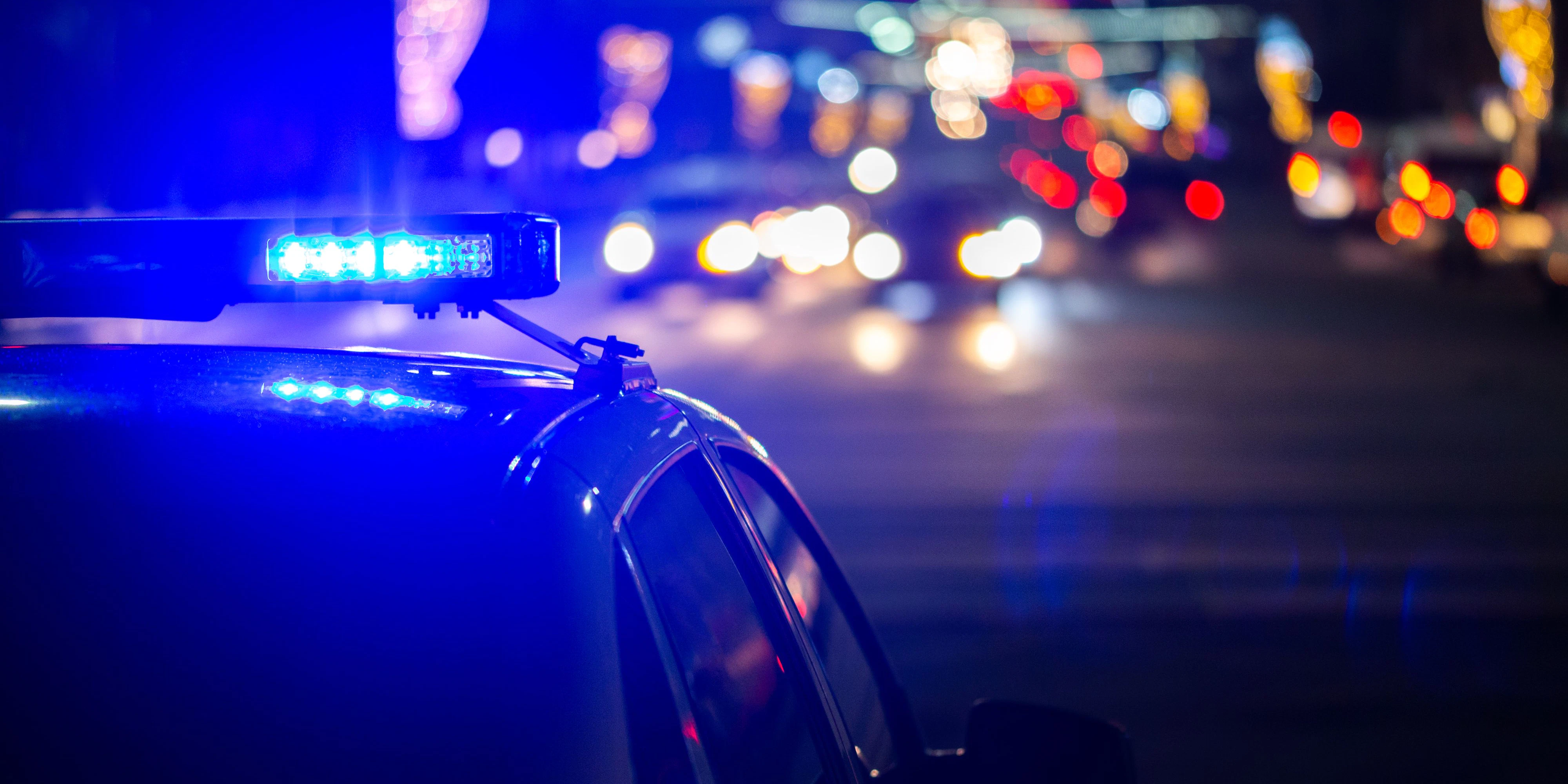 police car lights at night in city with selective focus and bokeh.
