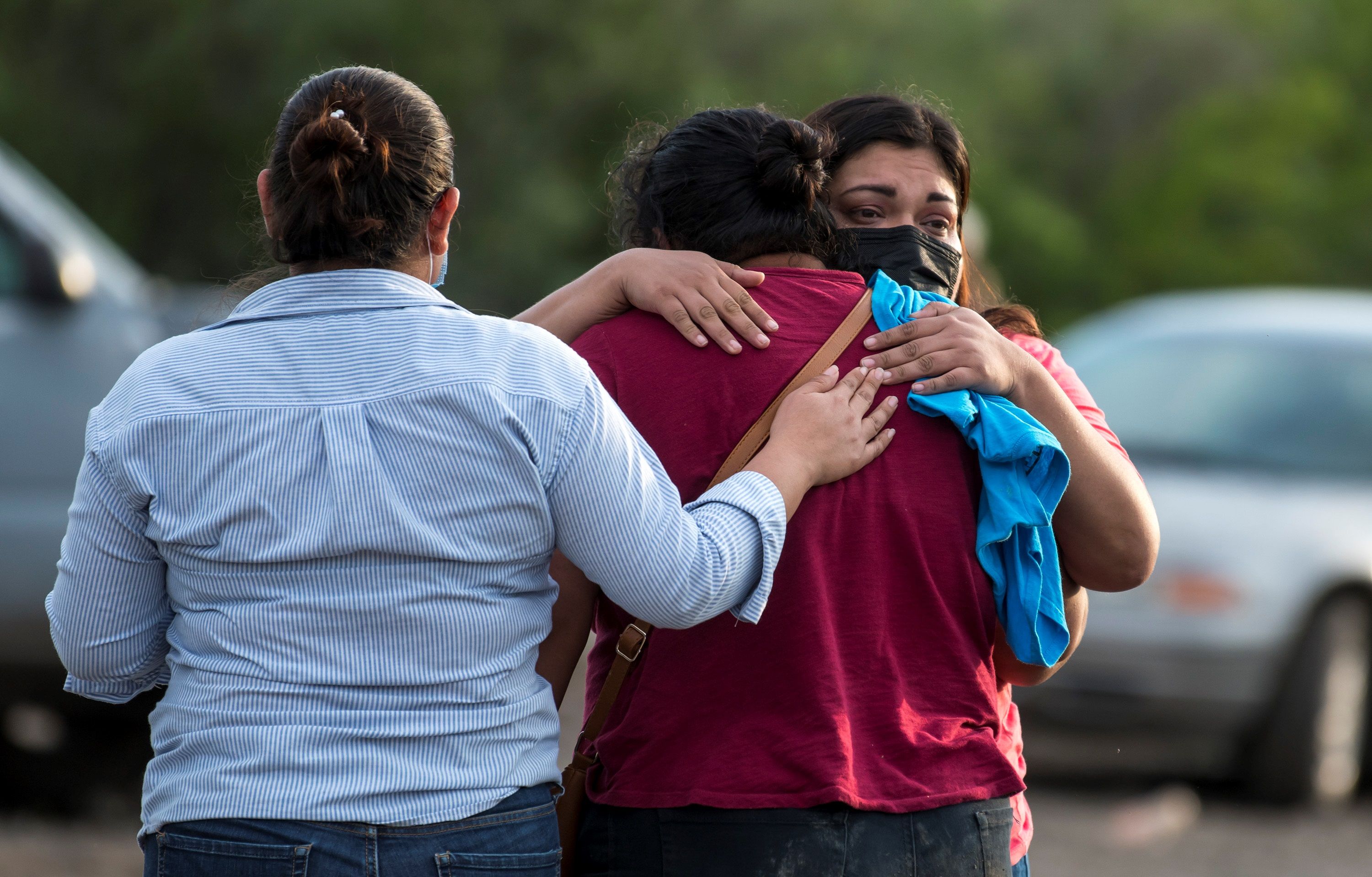 epaselect epa09248838 Relatives of miners hug as they await for information about their loved ones after the flooding and the collapse of a mine in the municipality of Muzquiz, Coahuila state, Mexico, 04 June 2021. At least seven miners were trapped on Friday by the flood and the collapse of a mine in the Mexican municipality of Muzquiz, in the northern state of Coahuila, where officers of Civil Protection and the Army were dispatched for rescue work.  EPA-EFE/Miguel Sierra