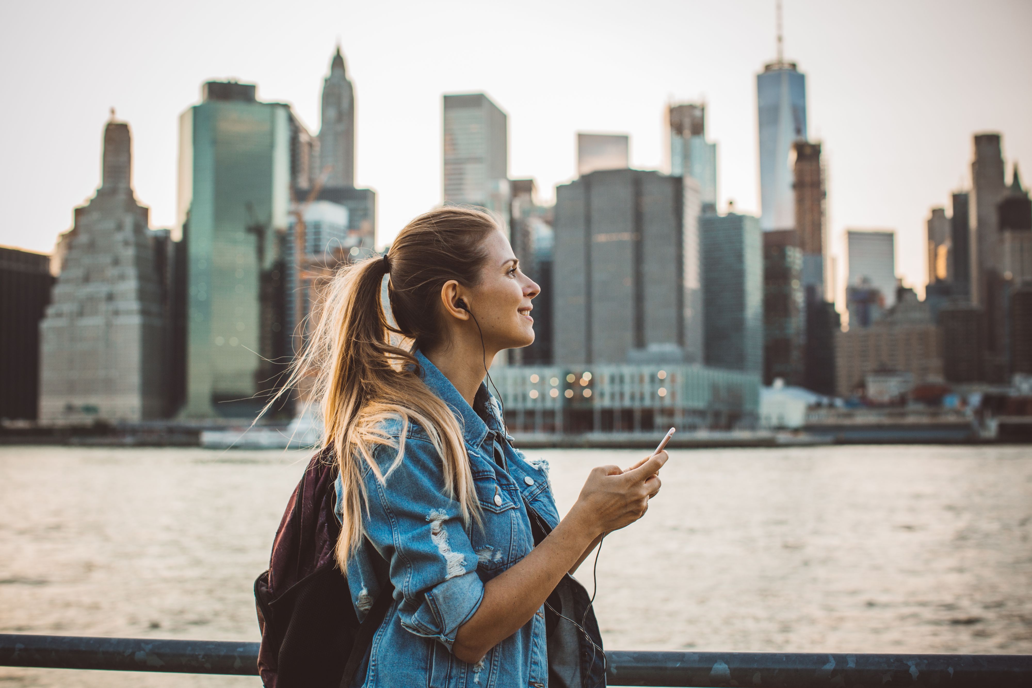 Woman in New York  enjoying in skyline at dusk