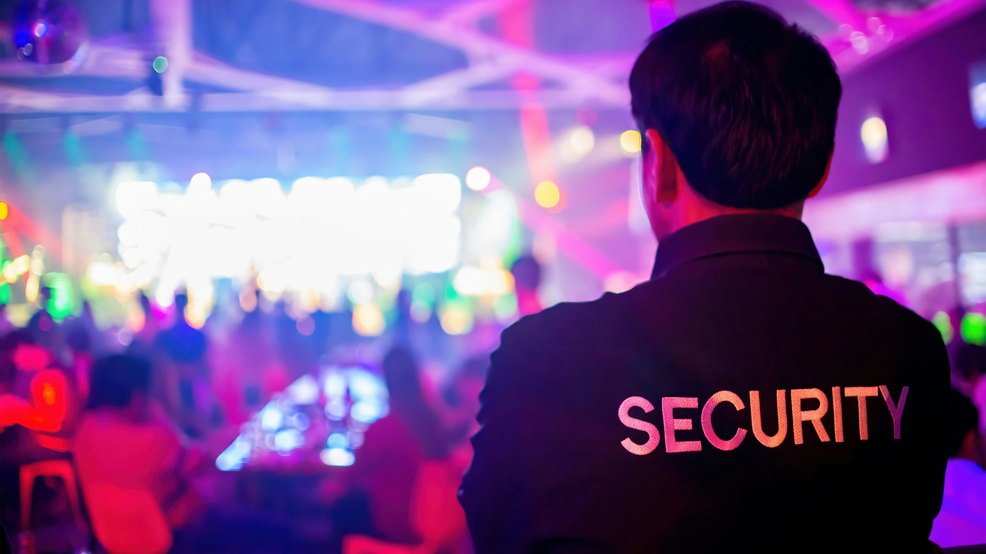 Security guard  are regulating the situation of safety in an event concert in a nightclub.