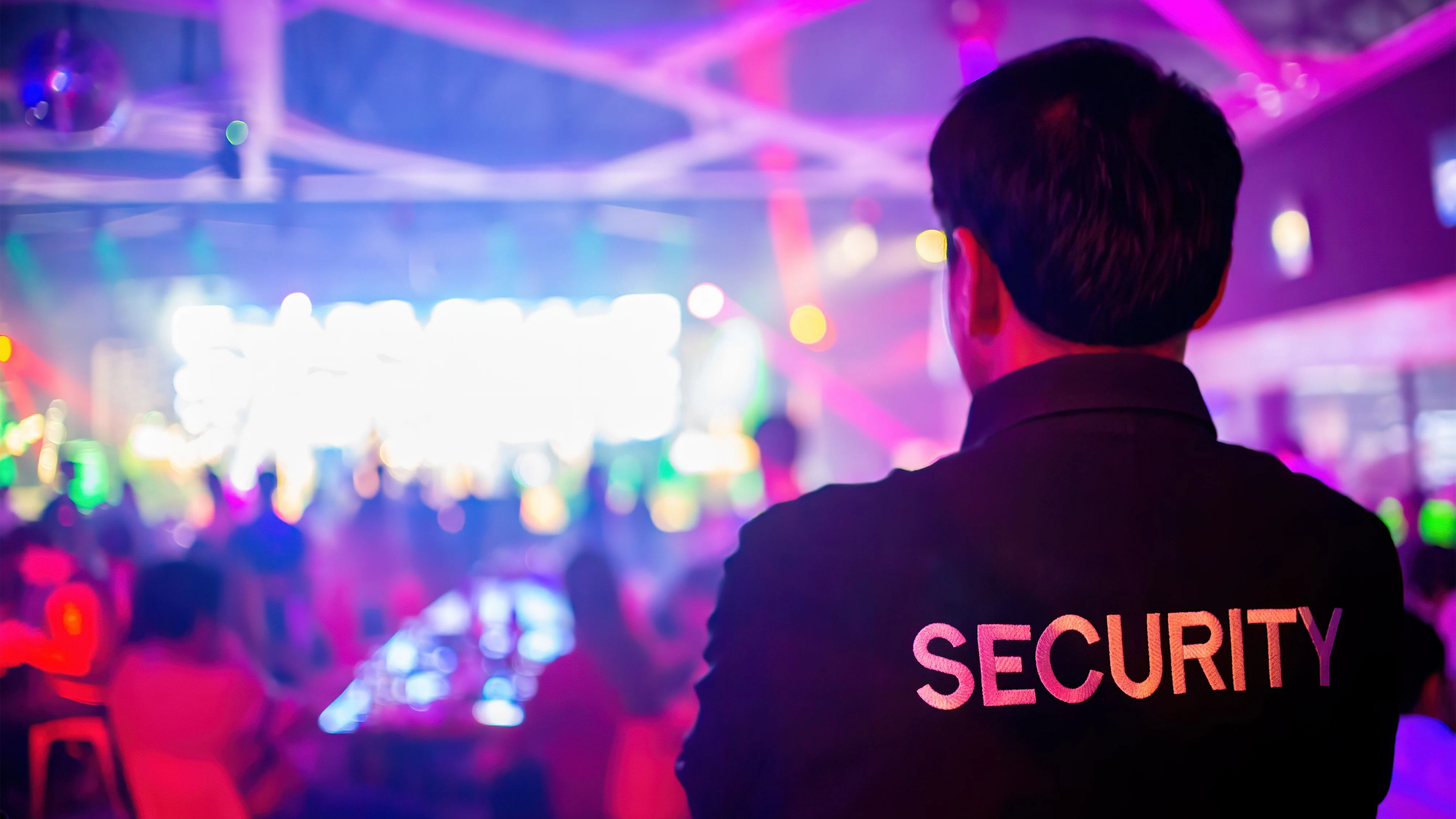 Security guard  are regulating the situation of safety in an event concert in a nightclub.