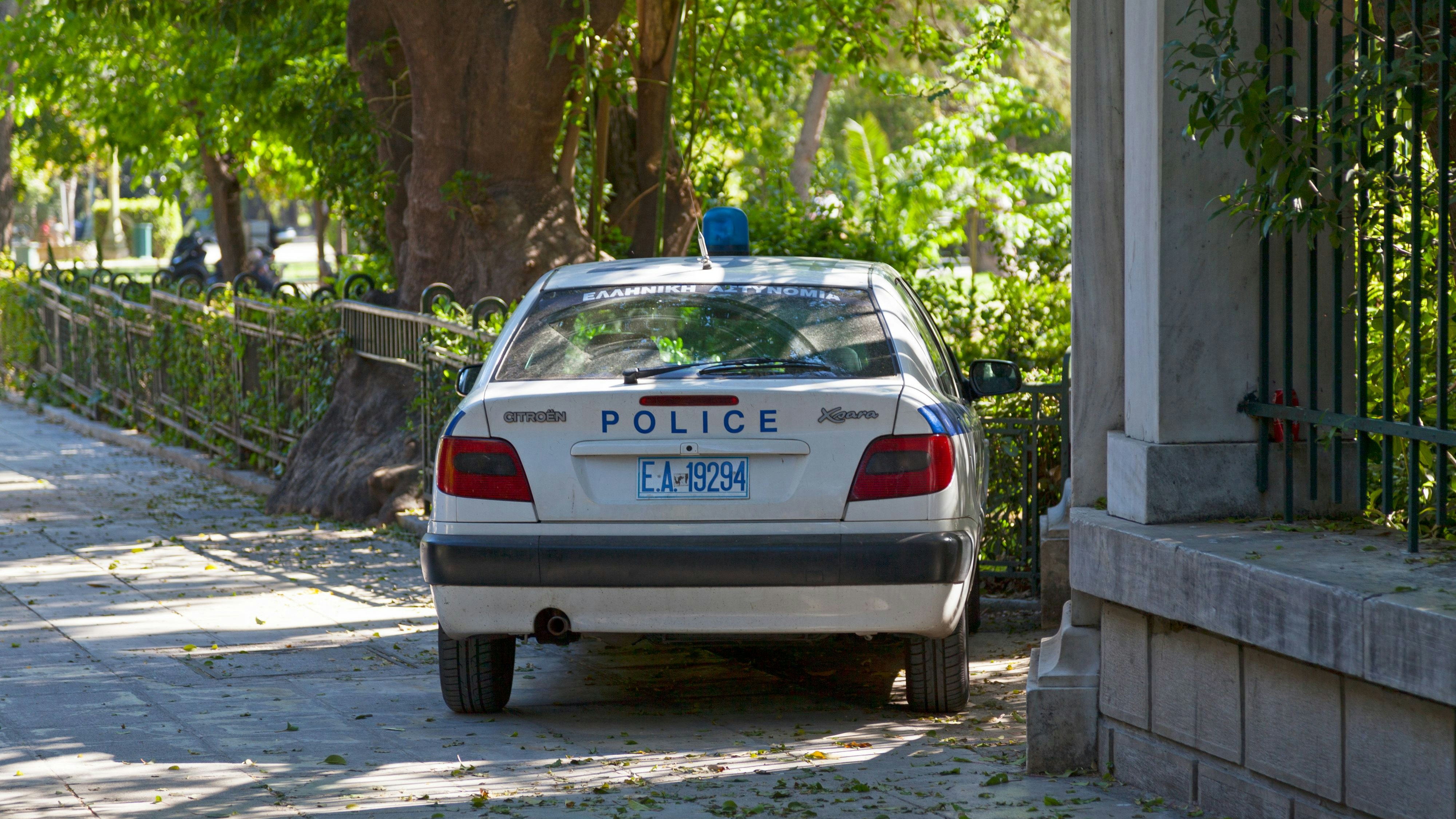 Athens, Greece - April 29 2019: Car of the Hellenic Police (Greek: Ελληνική Αστυνομία, Elliniki Astynomia, abbreviated ΕΛ.ΑΣ.) parked outside a park.