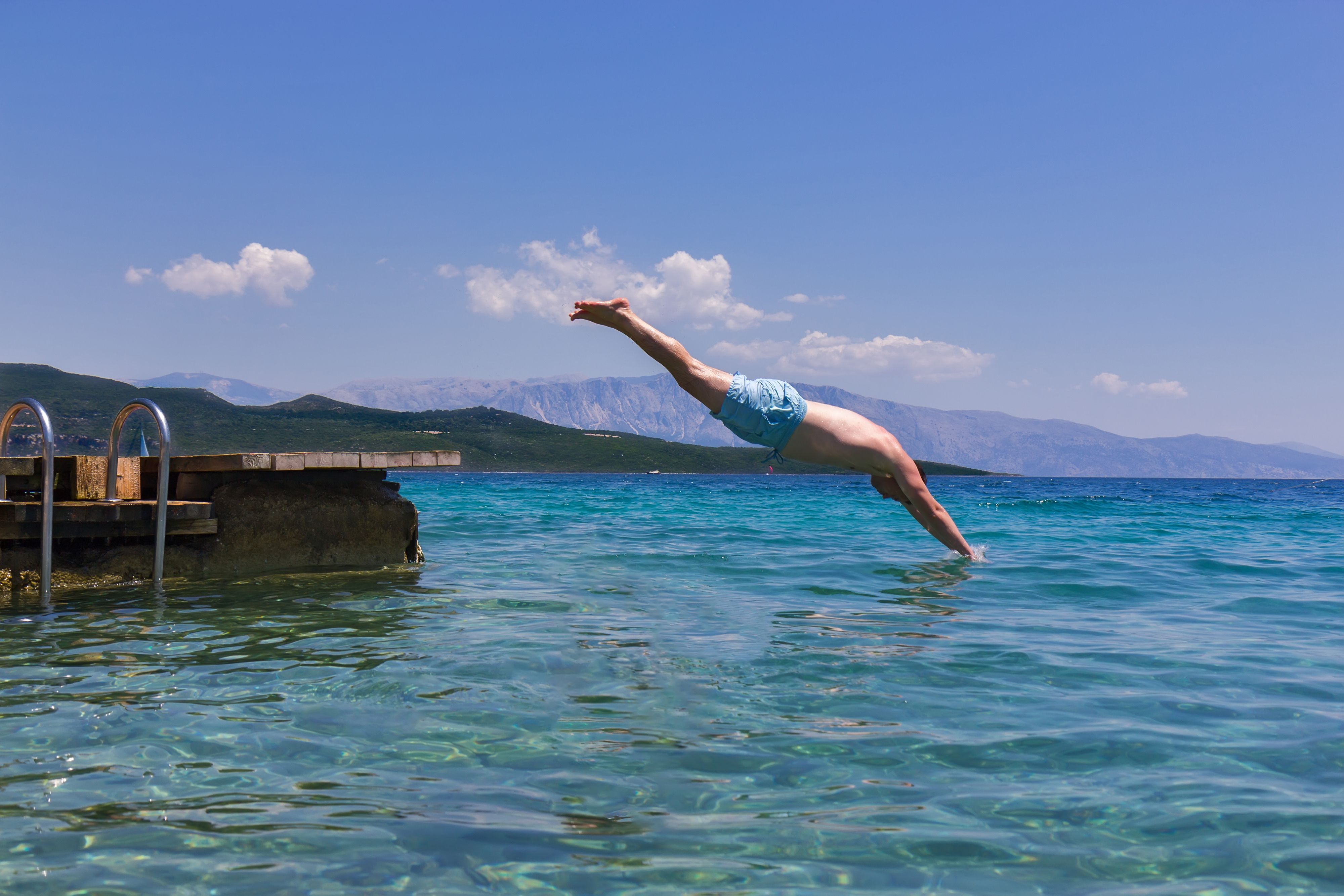 Swimmer jumping to sea water