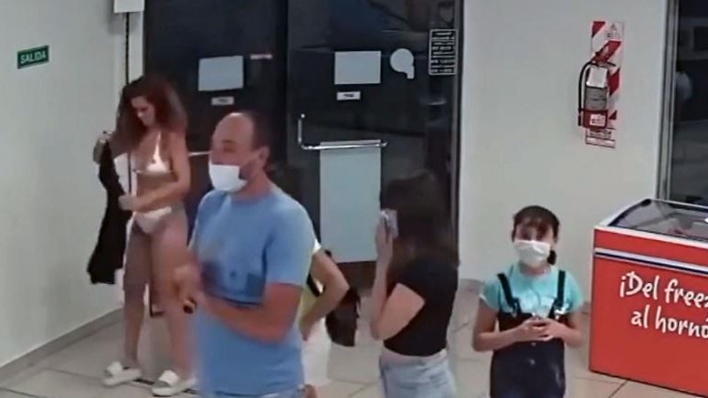 Frau zieht Kleid aus und trägt es als Maske