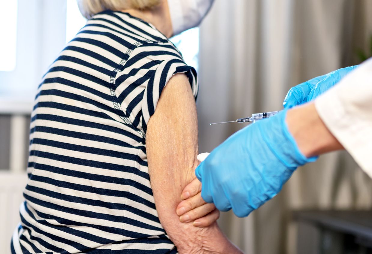 85-year-old woman receives the covid-19 vaccine from a doctor at home. Vaccination of the elderly. An elderly woman is vaccinated against COVID-19 in a nursing home.