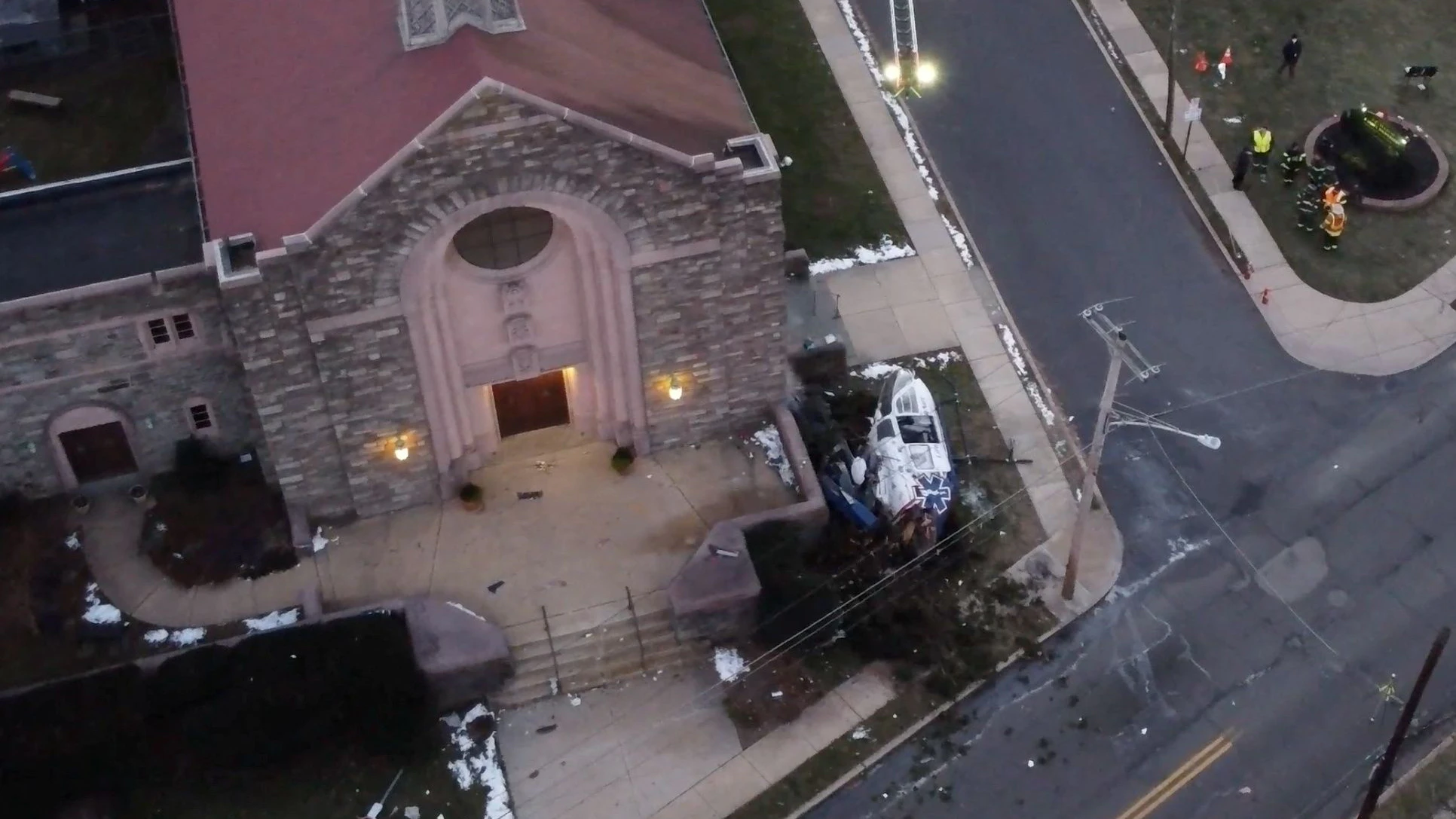 Debris of a medical helicopter that crashed is seen as first responders work at the site, near Drexel Hill United Methodist Church, in Drexel Hill, Pennsylvania, U.S.,  January 11, 2022, in this still image obtained from a social media video. Video taken with a drone. Khayree Robinson - Heredij Outreach Inc./via REUTERS THIS IMAGE HAS BEEN SUPPLIED BY A THIRD PARTY. MANDATORY CREDIT. NO RESALES. NO ARCHIVES.