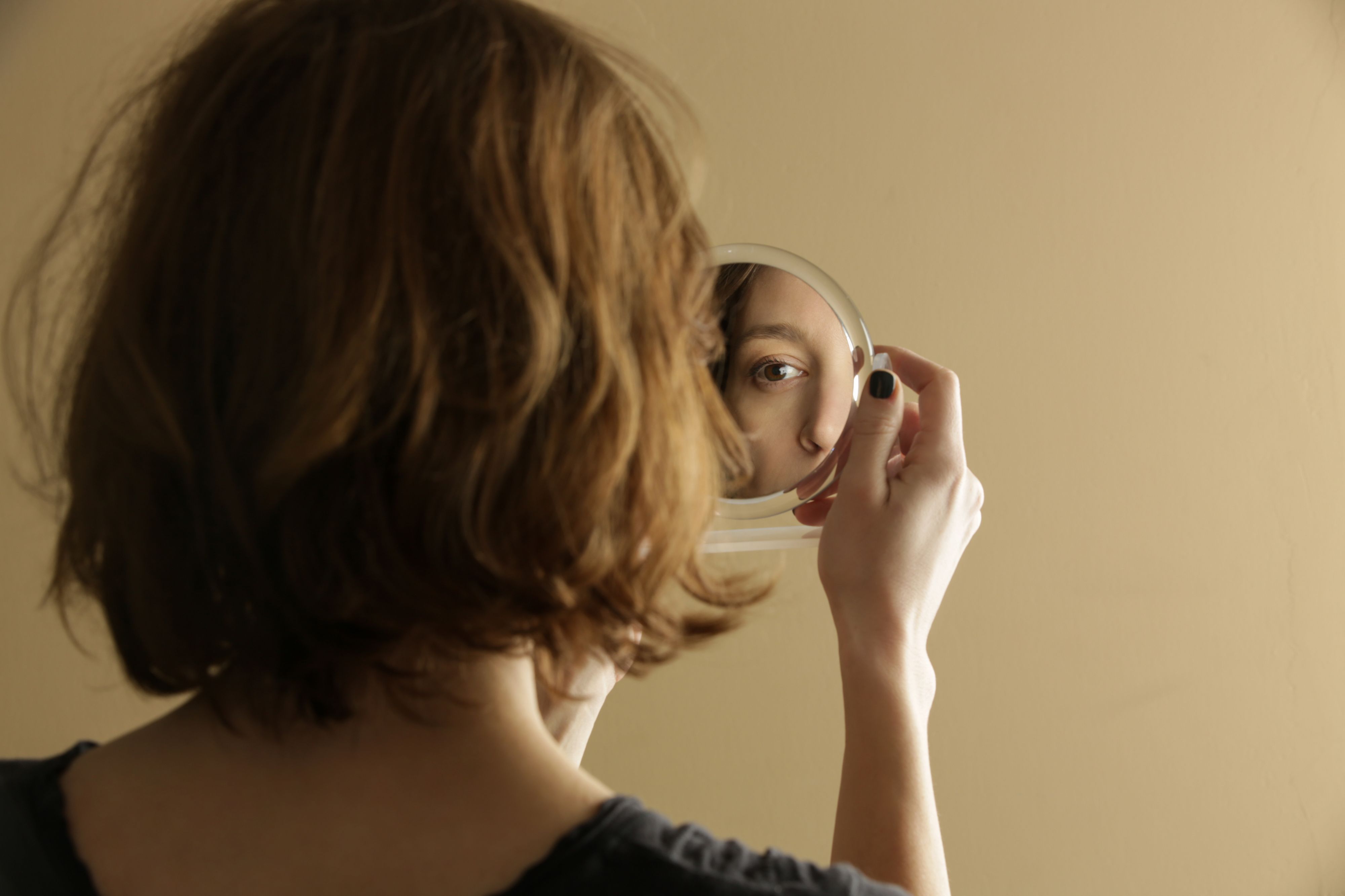 Mirror reflection of a woman's face, studio shot