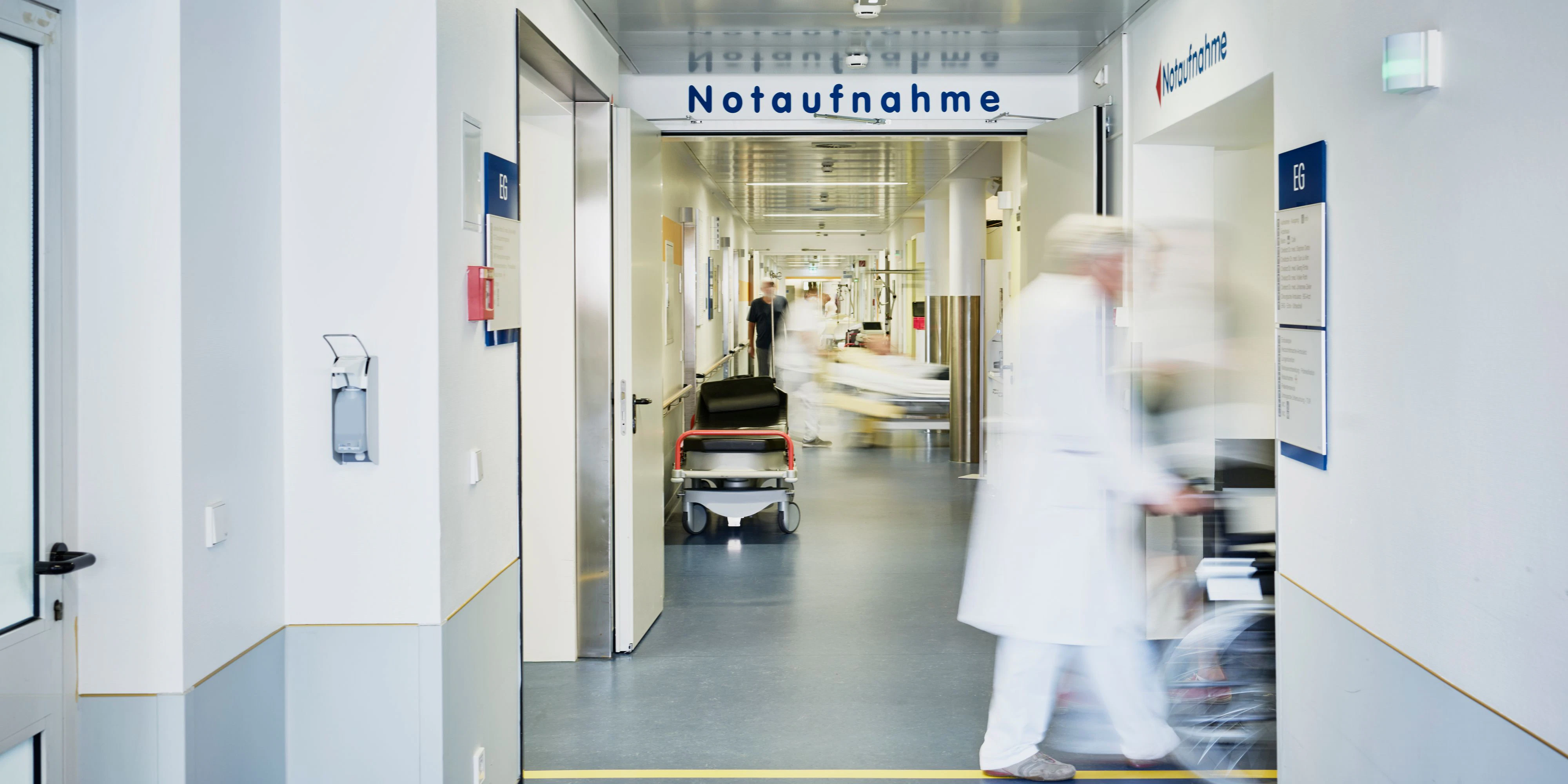 Emergency admission entrance hospital with doctor wheelchair and patient in motion blur in the corridor