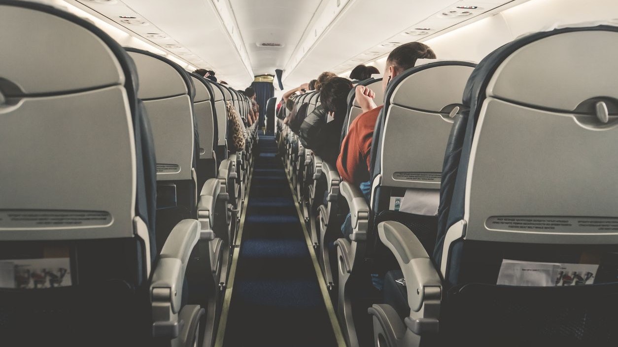 Interior of airplane with passengers on seats waiting to taik off. Horizontal composition. boring flight in economy class aircraft salon. economy class