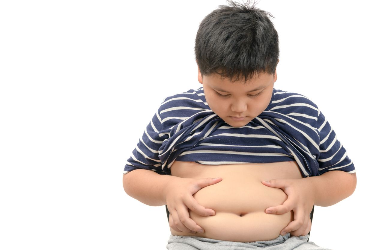 Obese fat boy overweight isolated on white background. Tight shirt, healthy concept