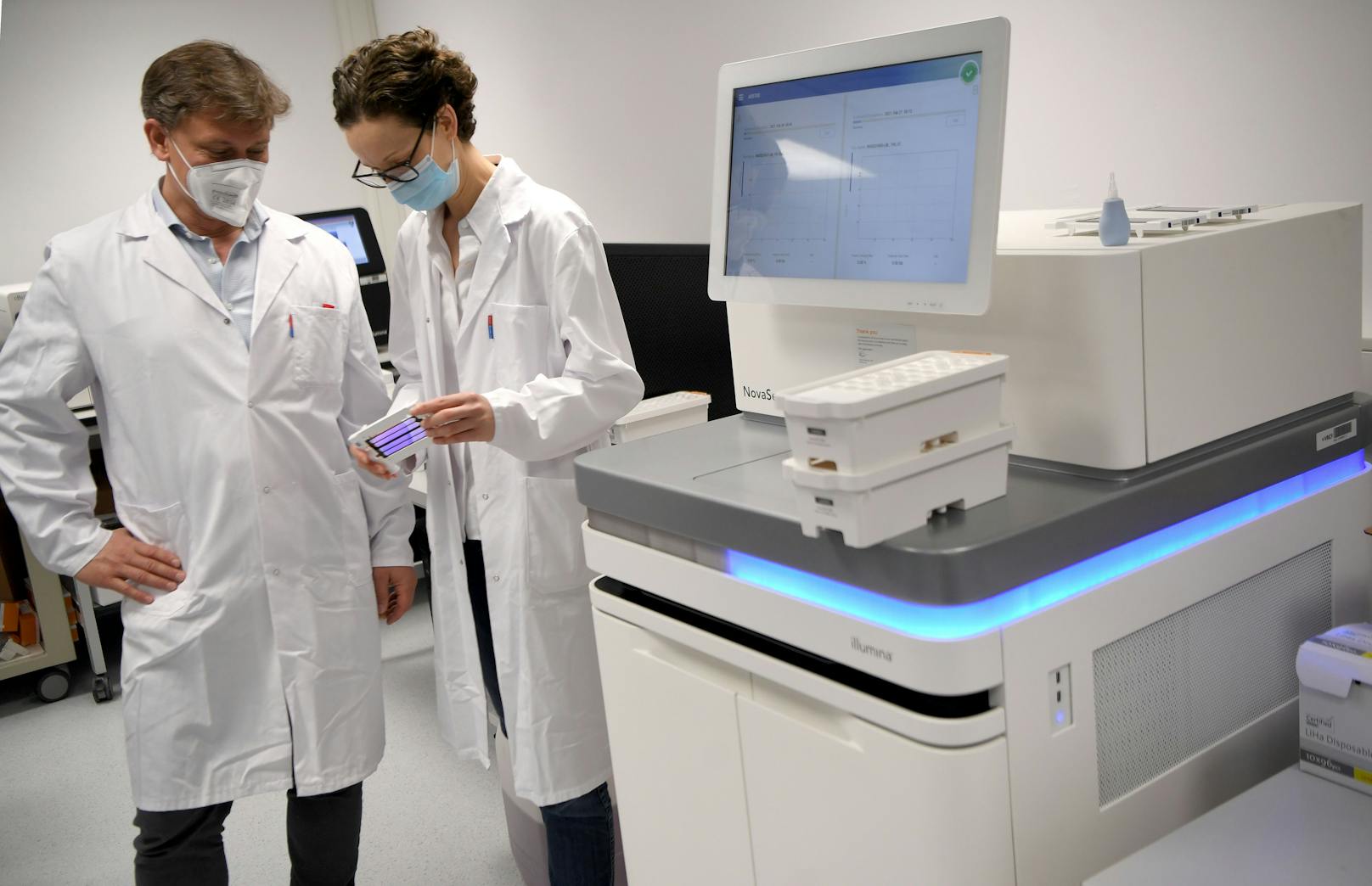 Die "Mutantenjäger" Luisa Cochella und Ullrich Elling bei einer DNA-Sequenzierungsmaschine in einem Labor der "IMBA" am BioCenter in Wien 2021.