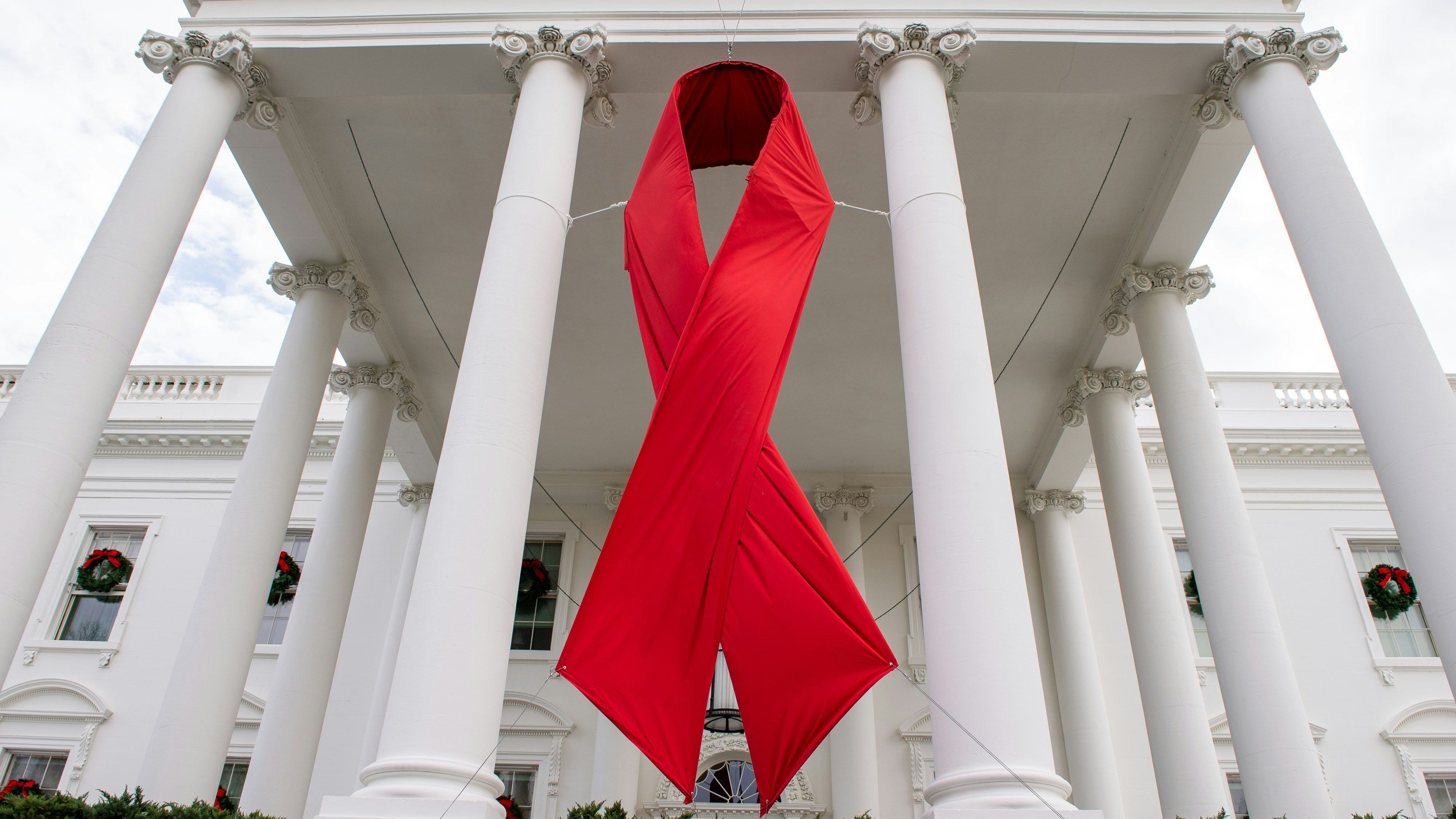 Download von www.picturedesk.com am 16.02.2022 (15:52).  December 1, 2020, Washington, District of Columbia, USA: A red ribbon in recognition of World AIDS Day hangs from the North Portico of the White House. - 20201201_PD10147 - Rechteinfo: Rights Managed (RM)