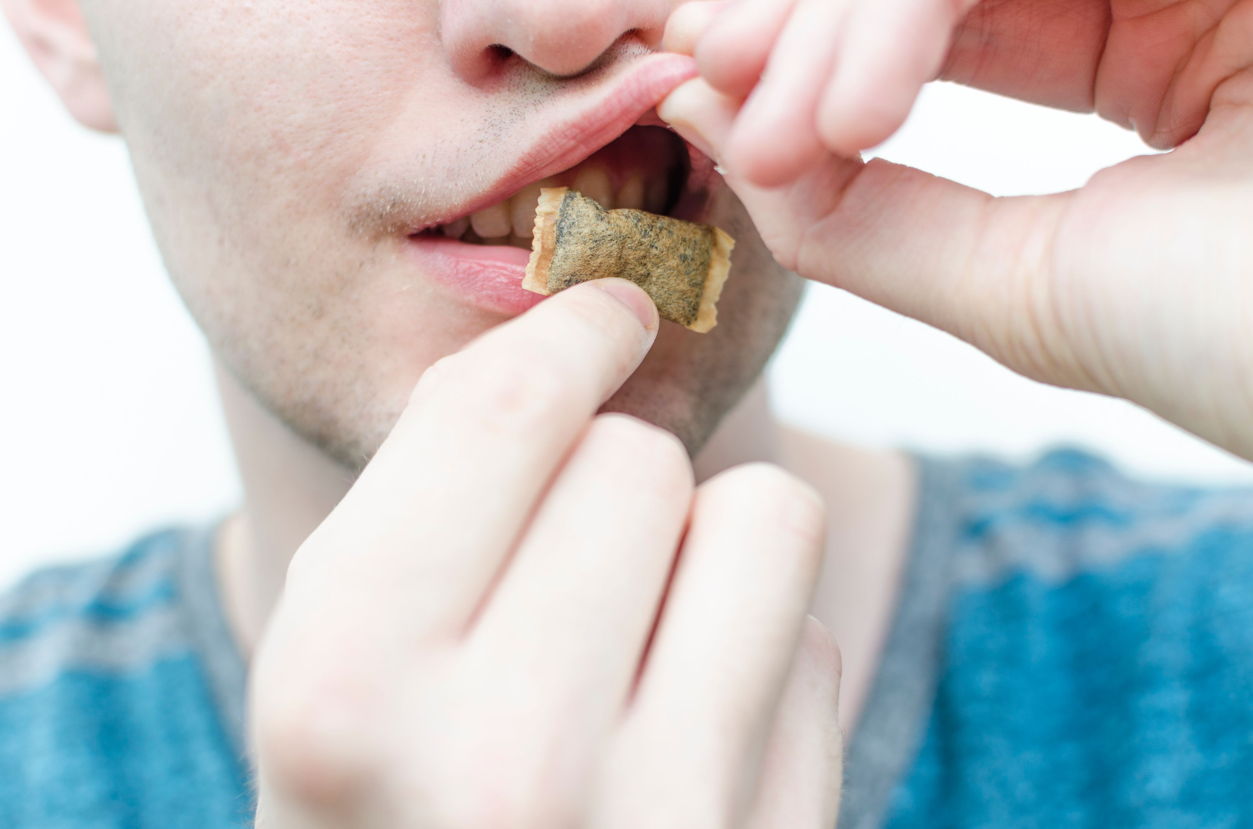 A man placing a snus under his lip. Snus, also commonly known as dip or chew, is a tobacco product that you use orally. 