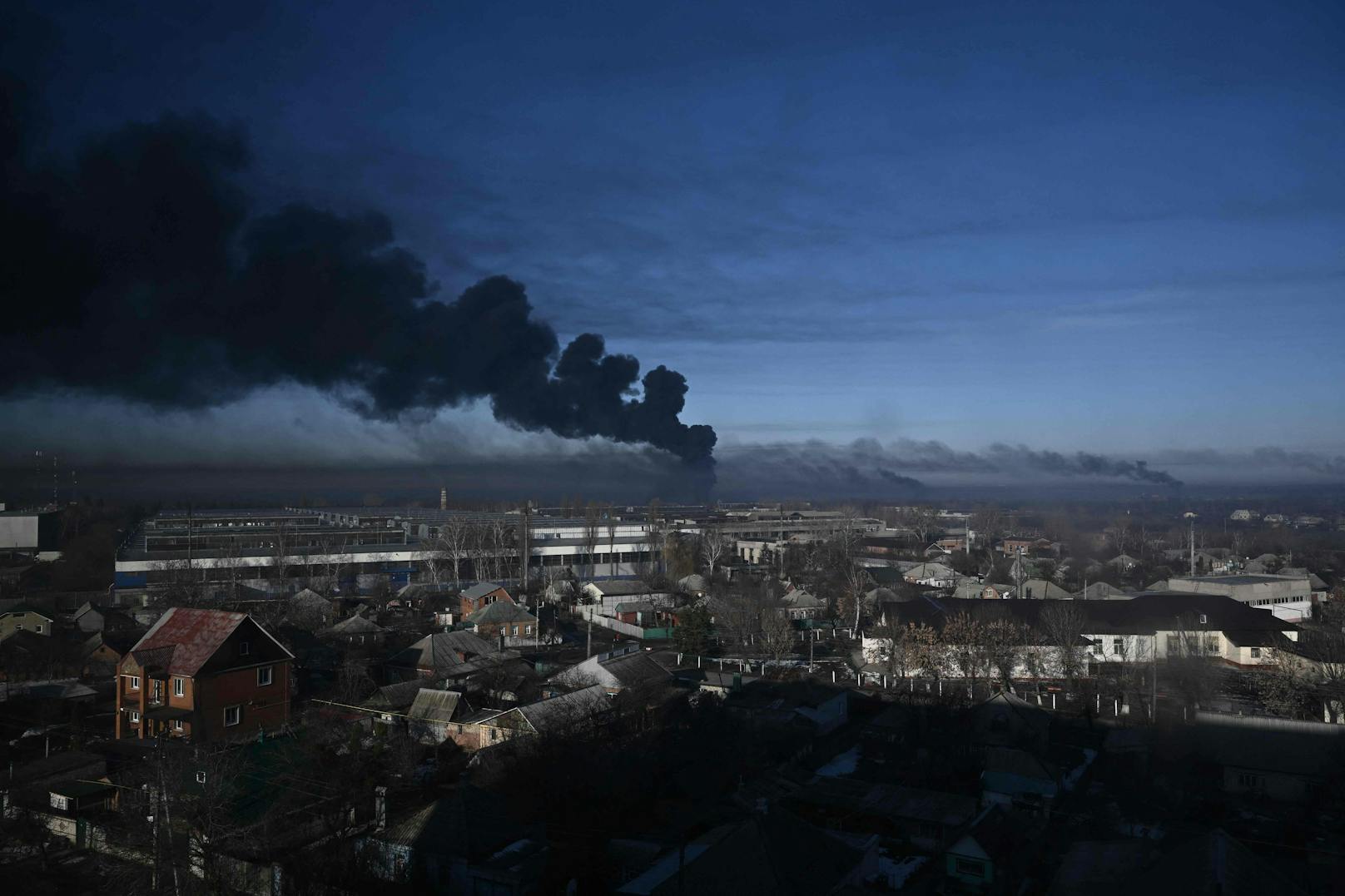 Eine schwarze Rauchsäule steigt von einem Militärflughafen nahe Charkiw auf – Russland hat einen Großangriff auf die Ukraine begonnen. (24. Februar, 2022)