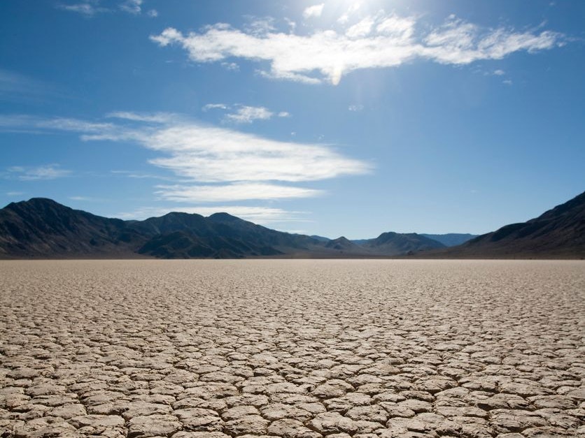 Vertical shot of the desert sun scorching the dry desert floor of the Racetrack Playa in Death Valley.