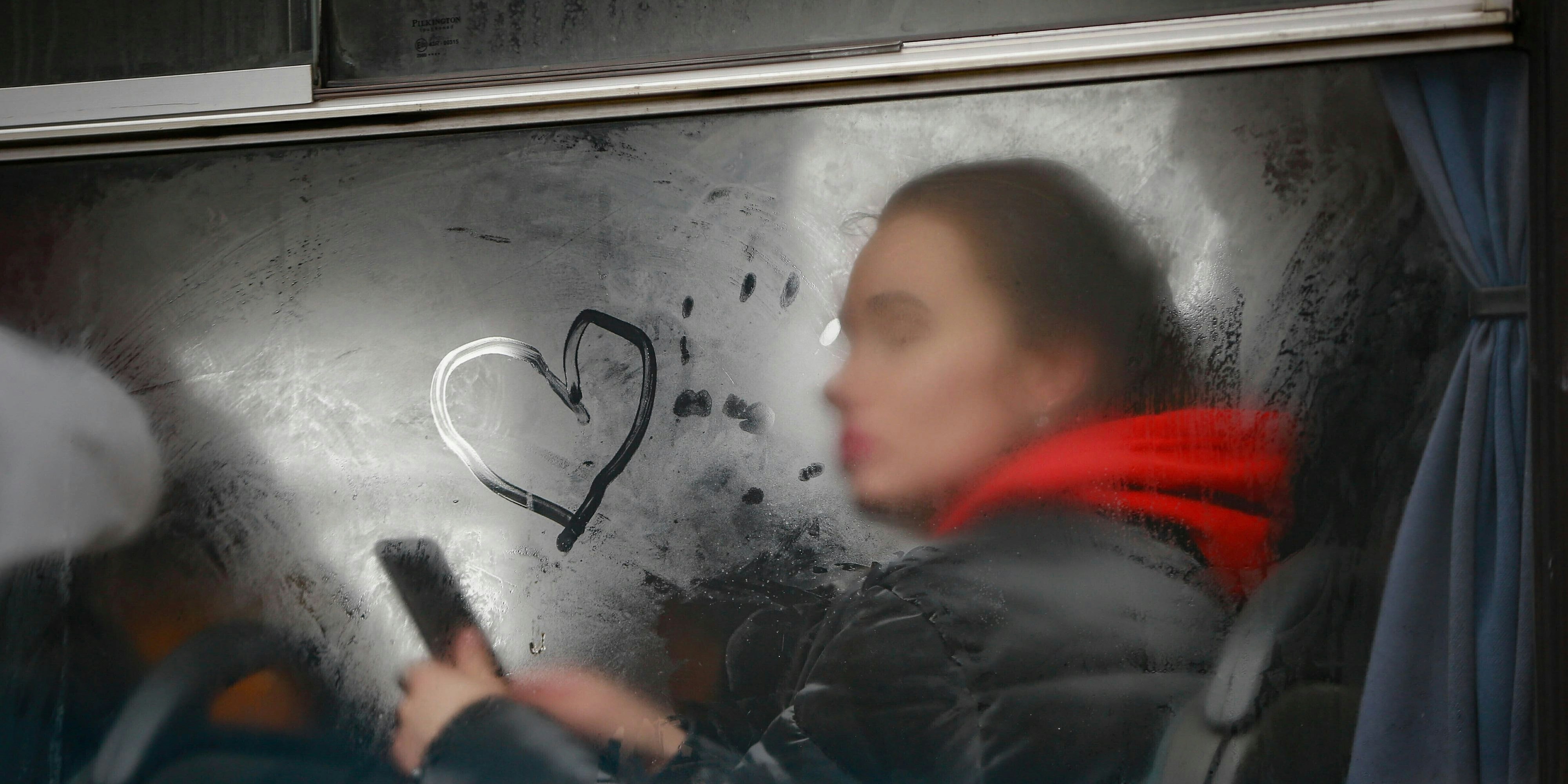 Eine ukrainische Frau schaut aus dem Fenster eines Busses in der Nähe des polnischen Grenzübergangs in Korczowa.