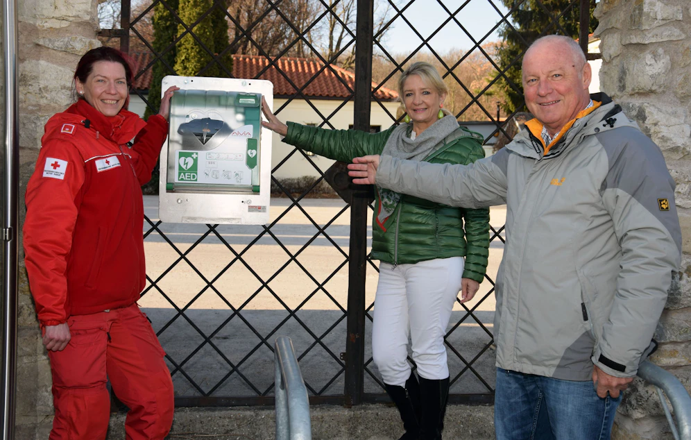 Christine Seidler vom Roten Kreuz, Roswitha Zieger und Friedrich Panny (von links) beim neuen Defi beim Haupteingang des Friedhofes.