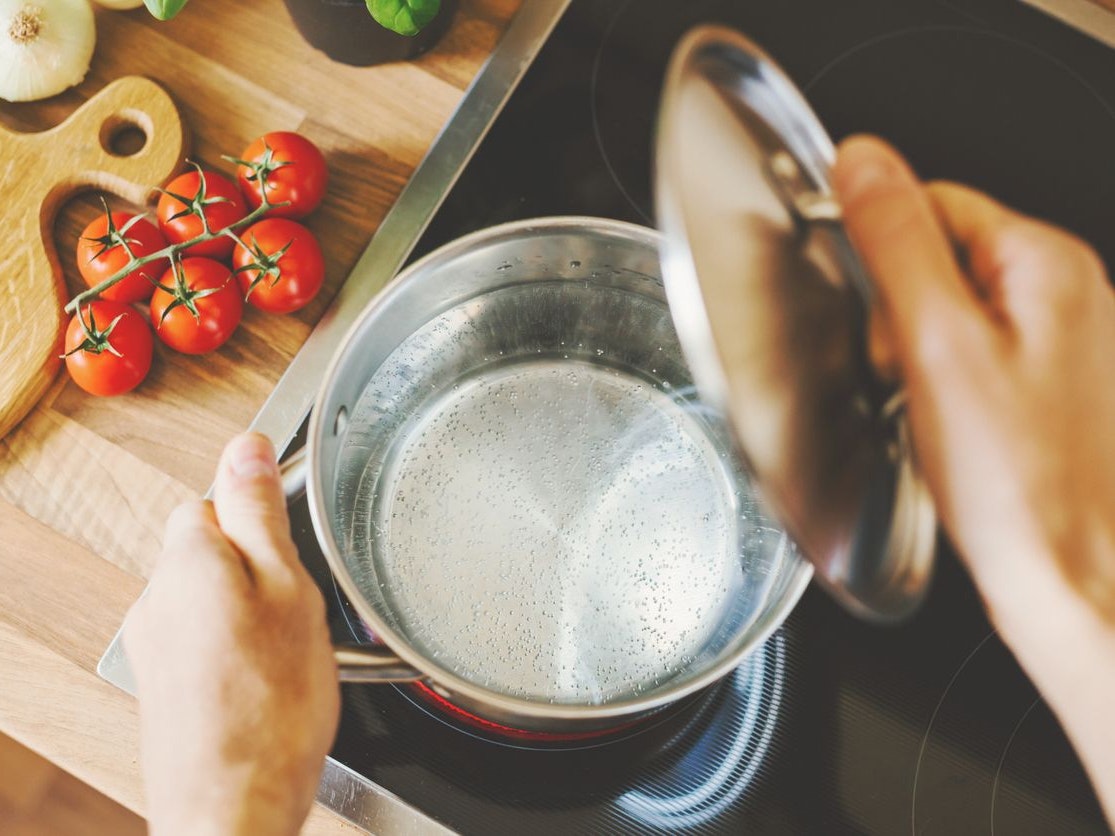 Process of cooking. Lifestyle background. Man checking boiling water in cooking pot. Closeup. Horizontal.
