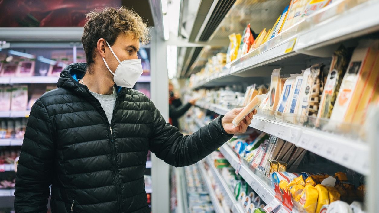 He looks down at selection of Swiss cheeses, making decisions
