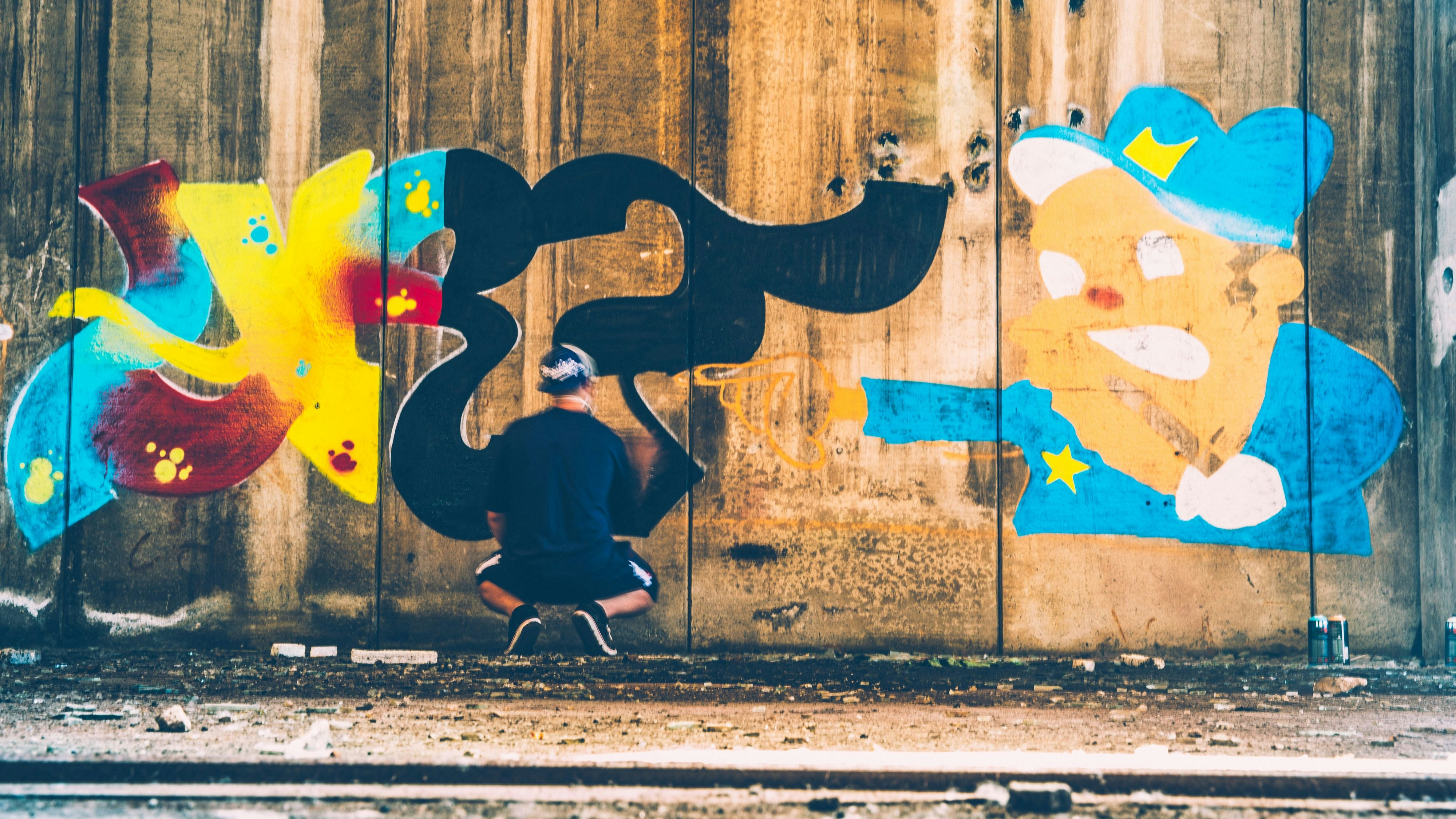 Artist creating a grafitti on a grungy wall